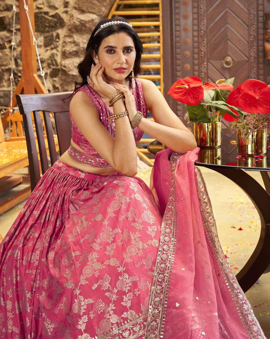 Woman seated wearing pink embroidered lehenga choli set Canada with silver floral embroidery and matching dupatta