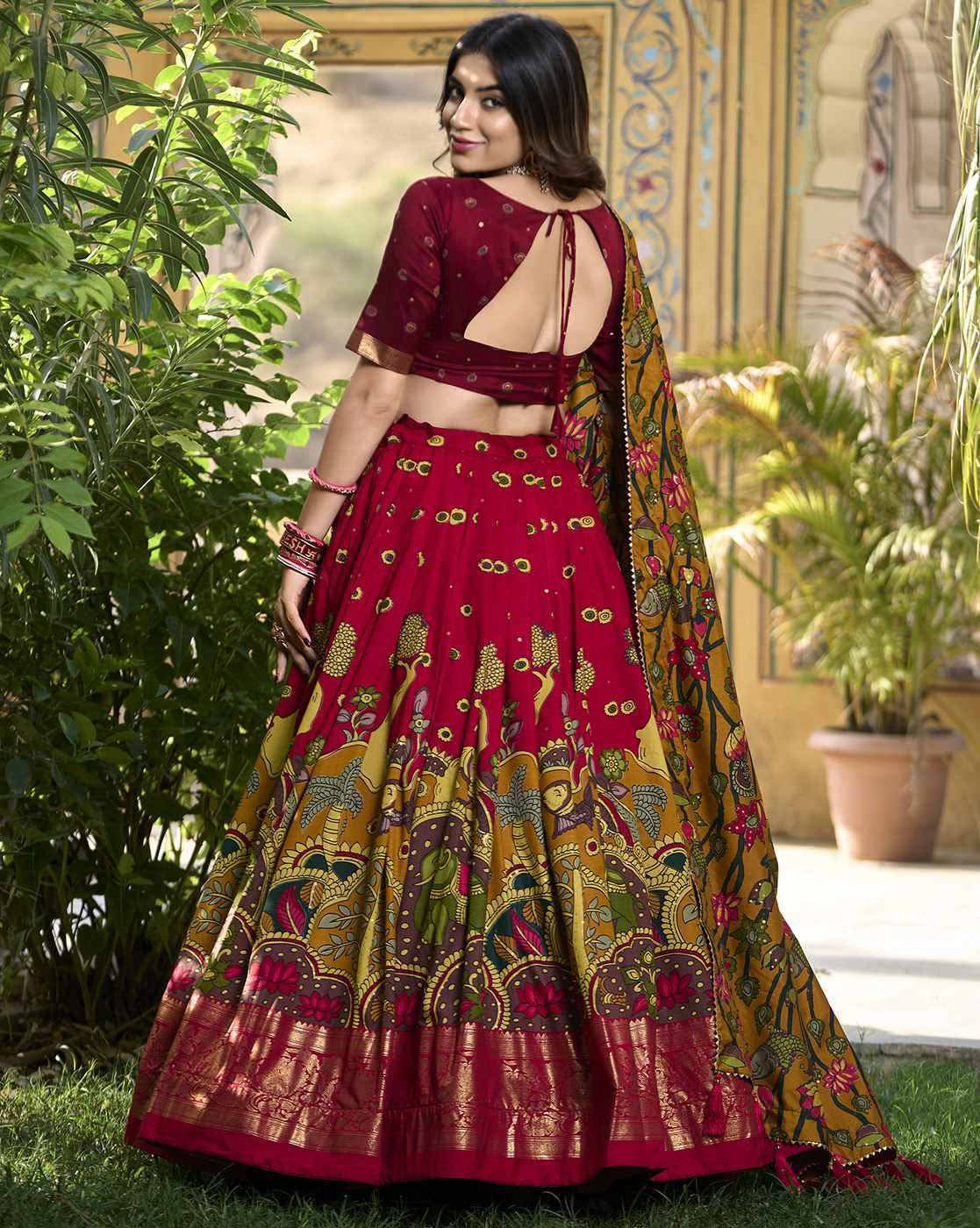 Woman in maroon printed lehenga with open back blouse and colorful dupatta traditional Lehenga Choli Set Canada
