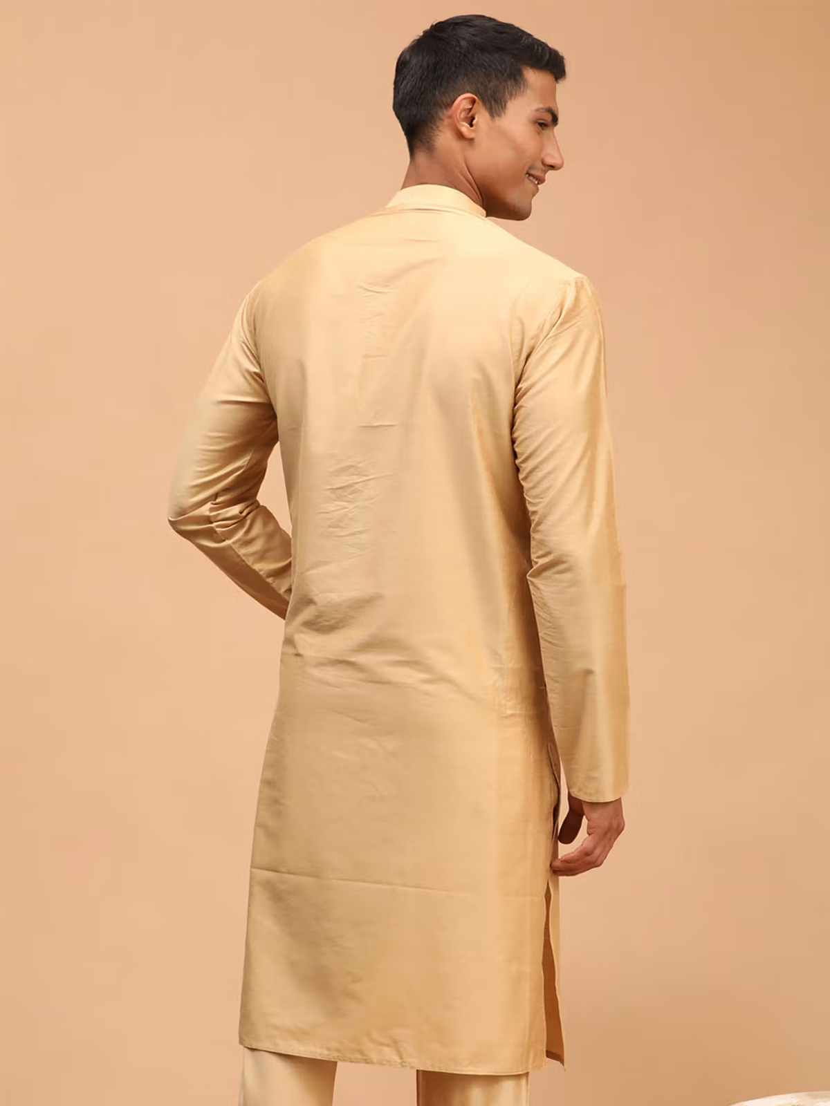 Rear view of a model wearing mens beige viscose kurta with long sleeves straight hem and side slit for formal occasions