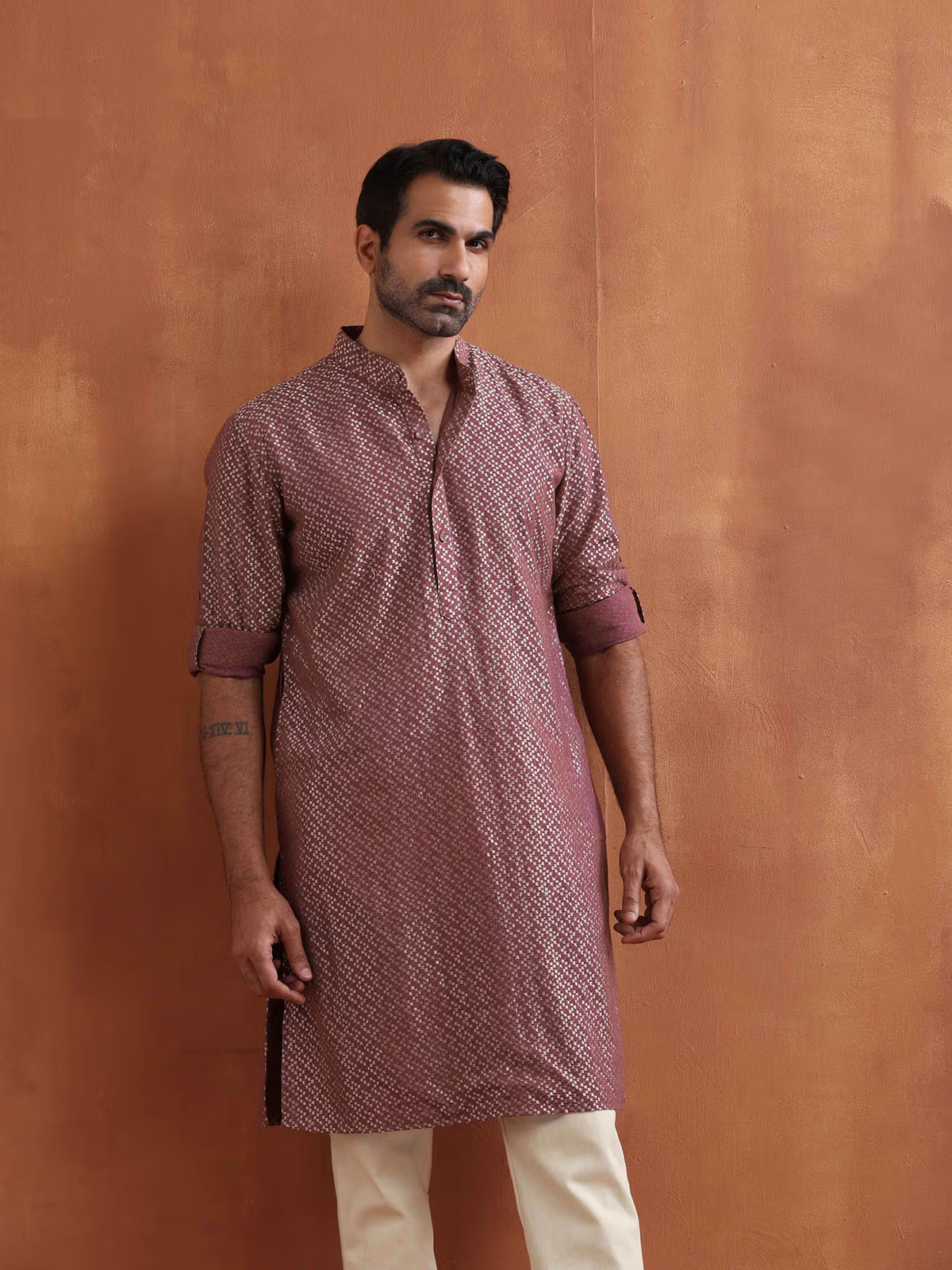 men's purple cotton kurta with mandarin collar patterned weave rolled sleeves and side slits paired with cream trousers