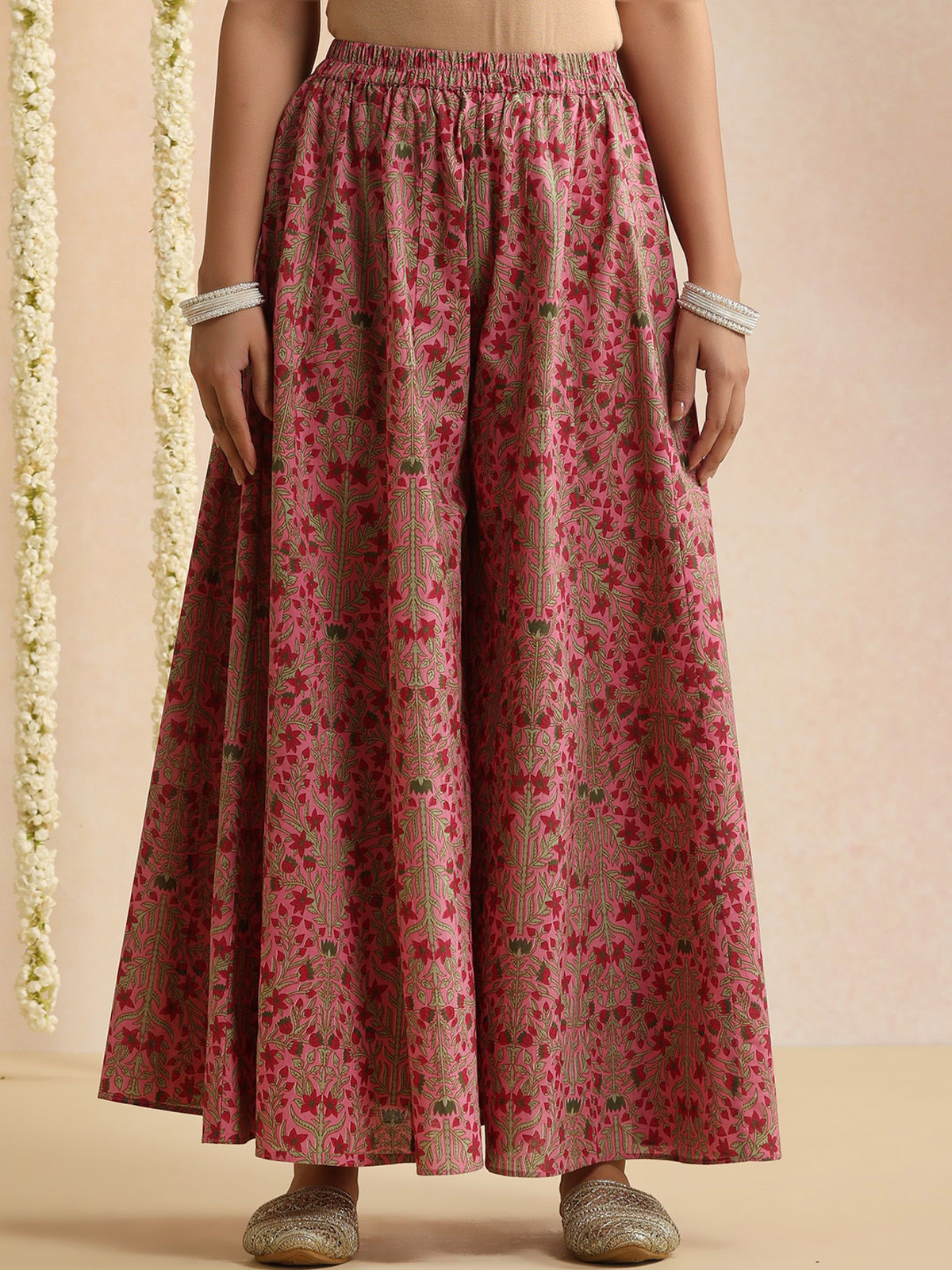 Aromie elegant bandhani kurta set featuring a pink floral printed flared skirt with elastic waist and traditional bangles