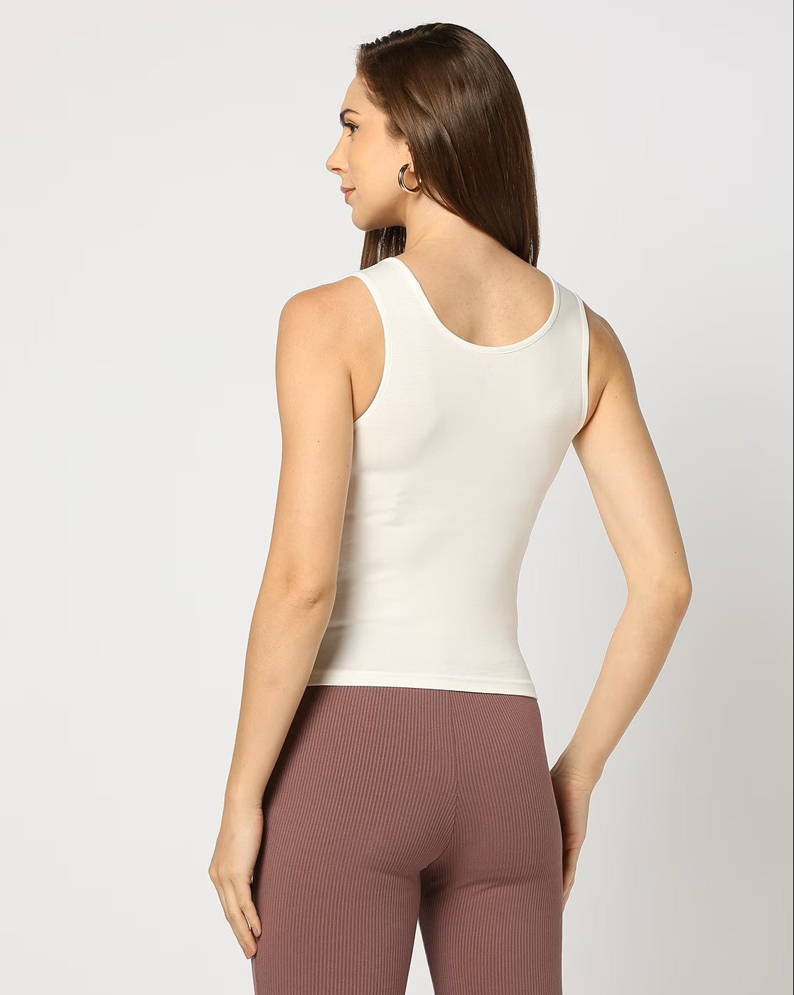 Aromie women's cotton tank top ivory back view on model slim fit scoop neck paired with mauve ribbed leggings