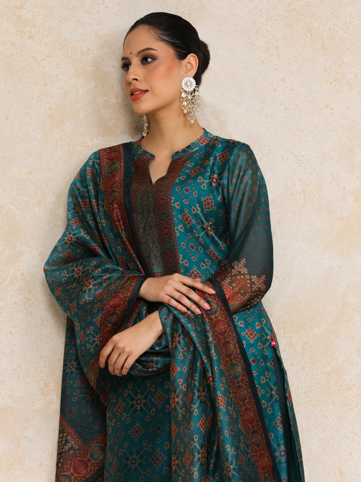 Elegant Floral Anarkali Kurta Set in teal fabric with intricate patterns and attractive design details