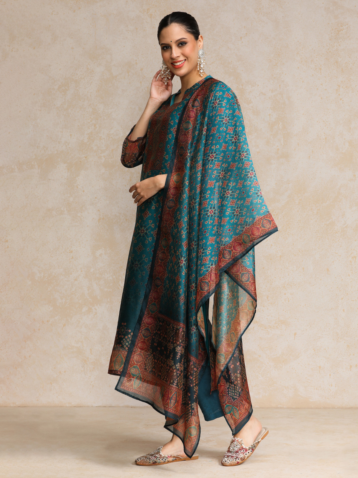 Aromie Floral Anarkali Kurta Set in teal with intricate patterns and elegant draping for festive occasions