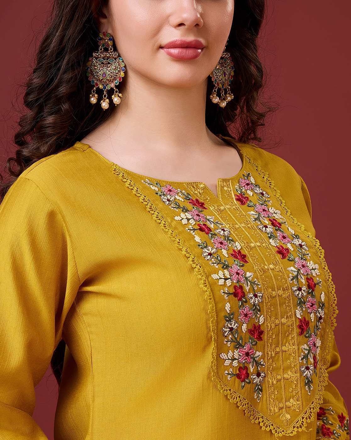 Aromie floral embroidered kurta set featuring intricate floral designs on a mustard-colored fabric