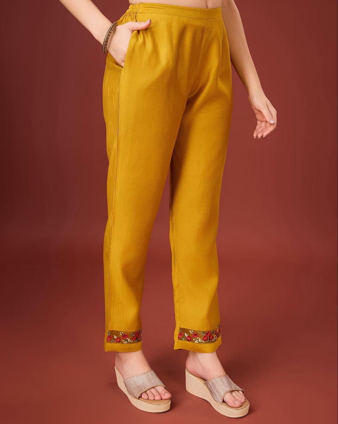 Aromie floral embroidered kurta set featuring mustard pants with vibrant embroidered hem detail