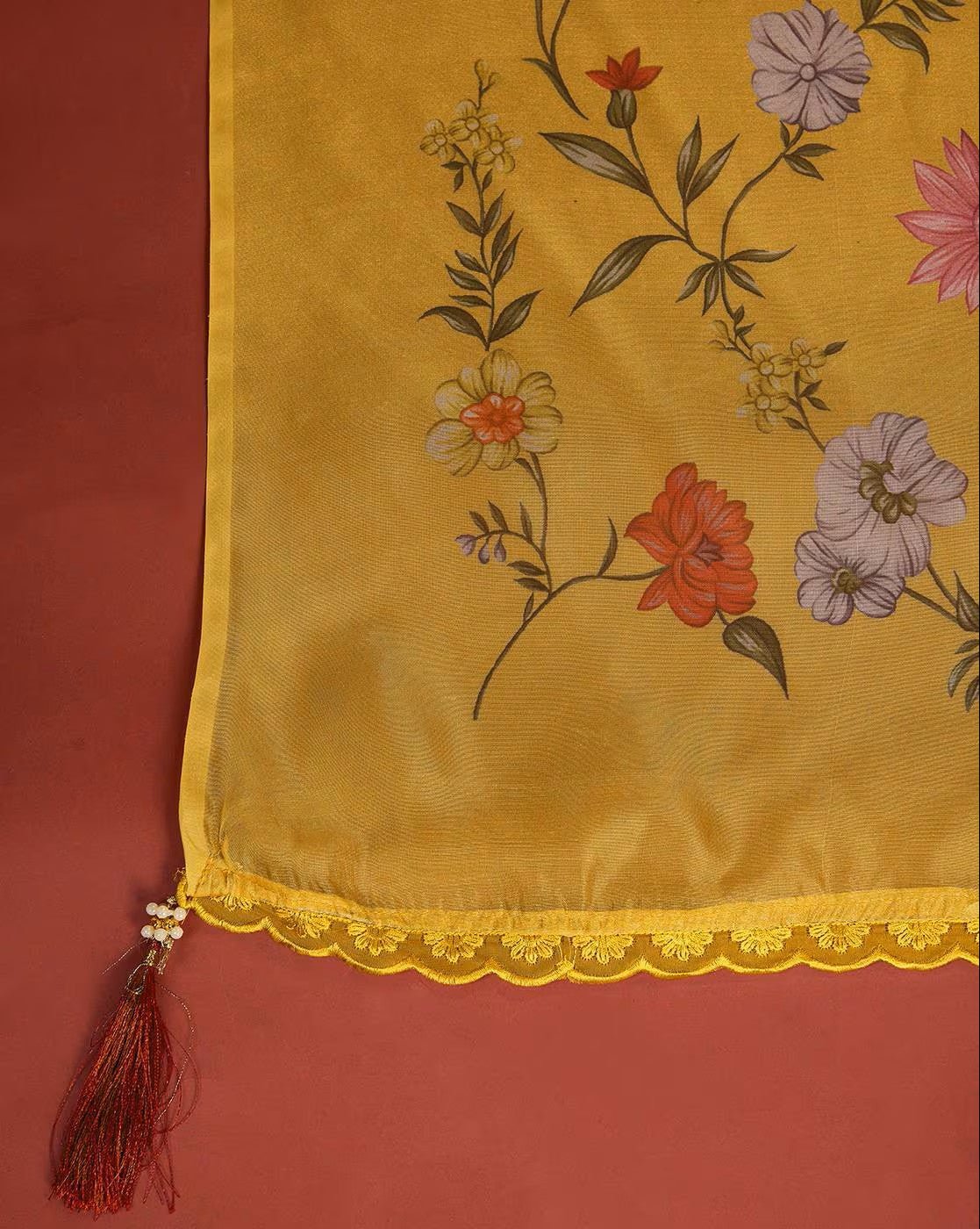 Floral embroidered kurta set with vibrant yellow fabric and decorative lace trim