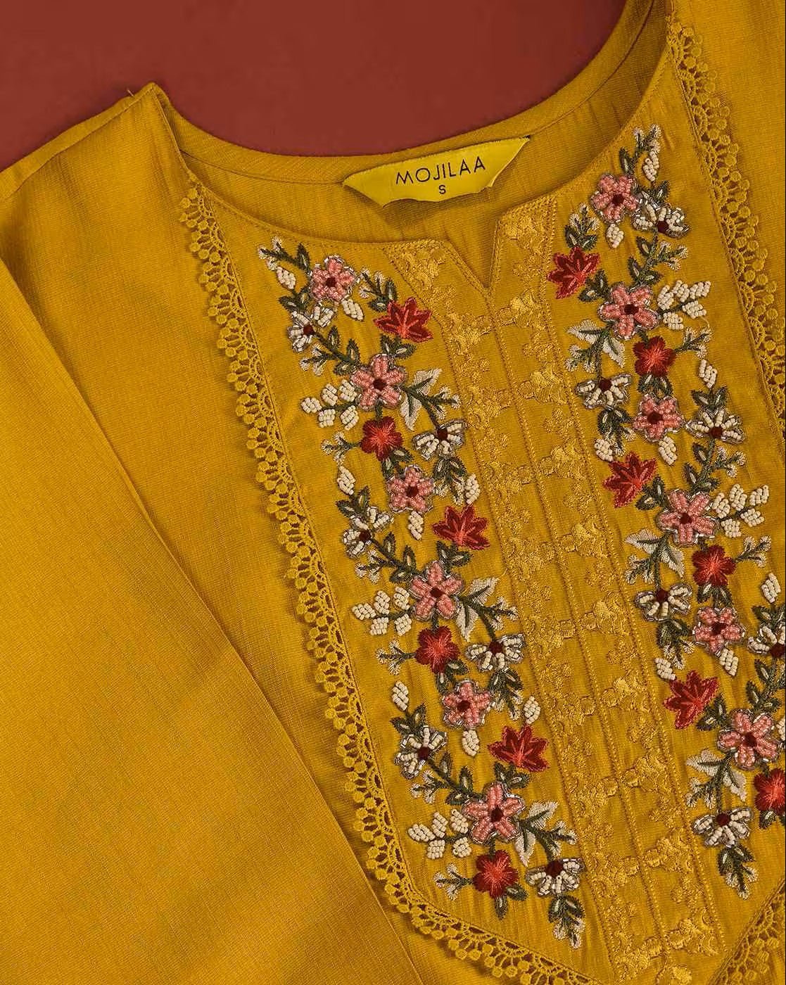 Floral embroidered kurta set in mustard yellow with intricate floral designs on the neckline
