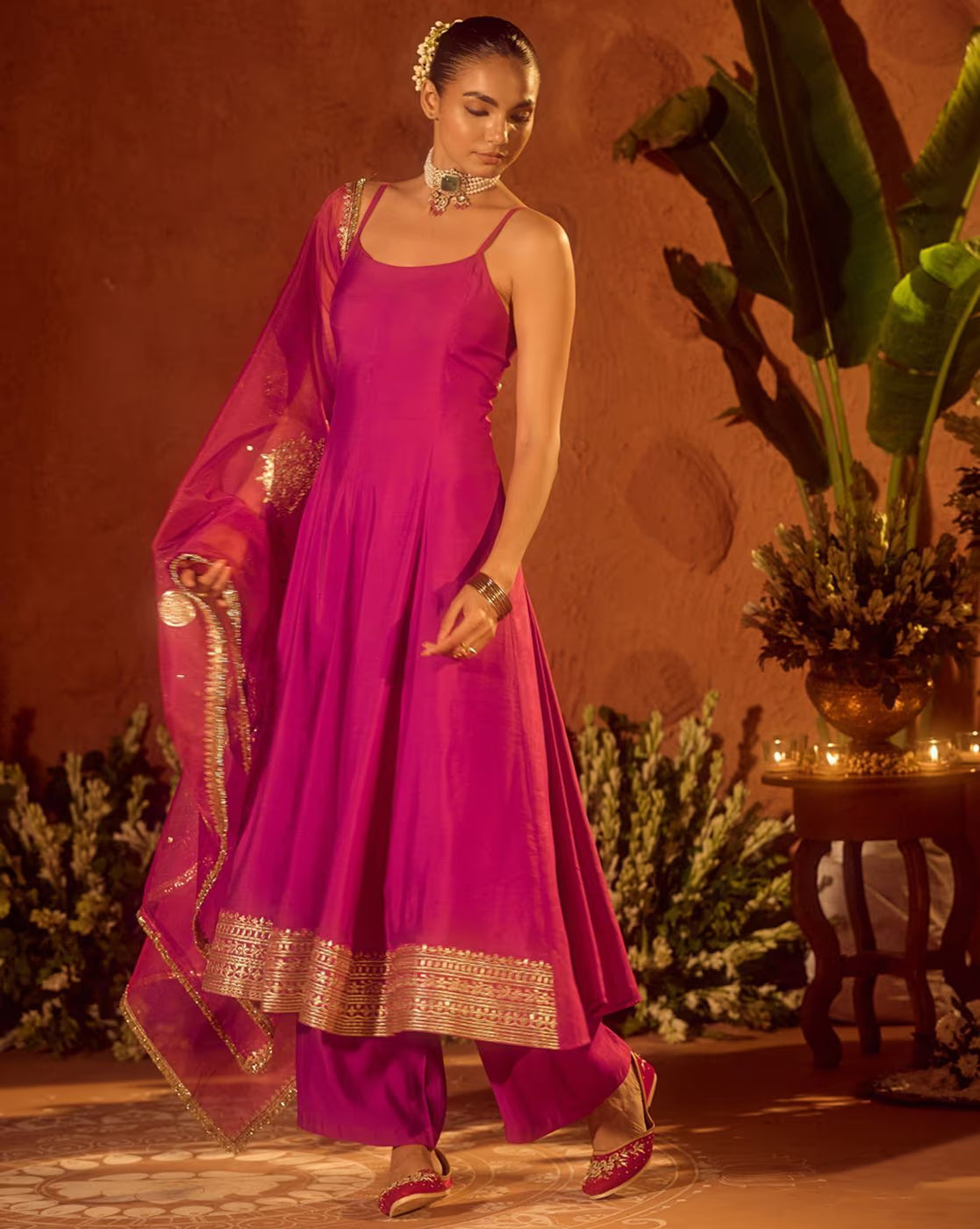 Aromie Floral Kurta Set for Women in vibrant pink with intricate gold detailing and elegant drape