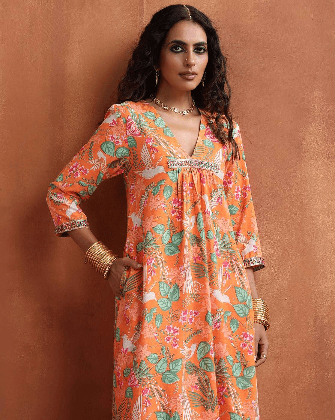 Aromie Floral Kurta Set for Women in vibrant orange with botanical prints and intricate detailing