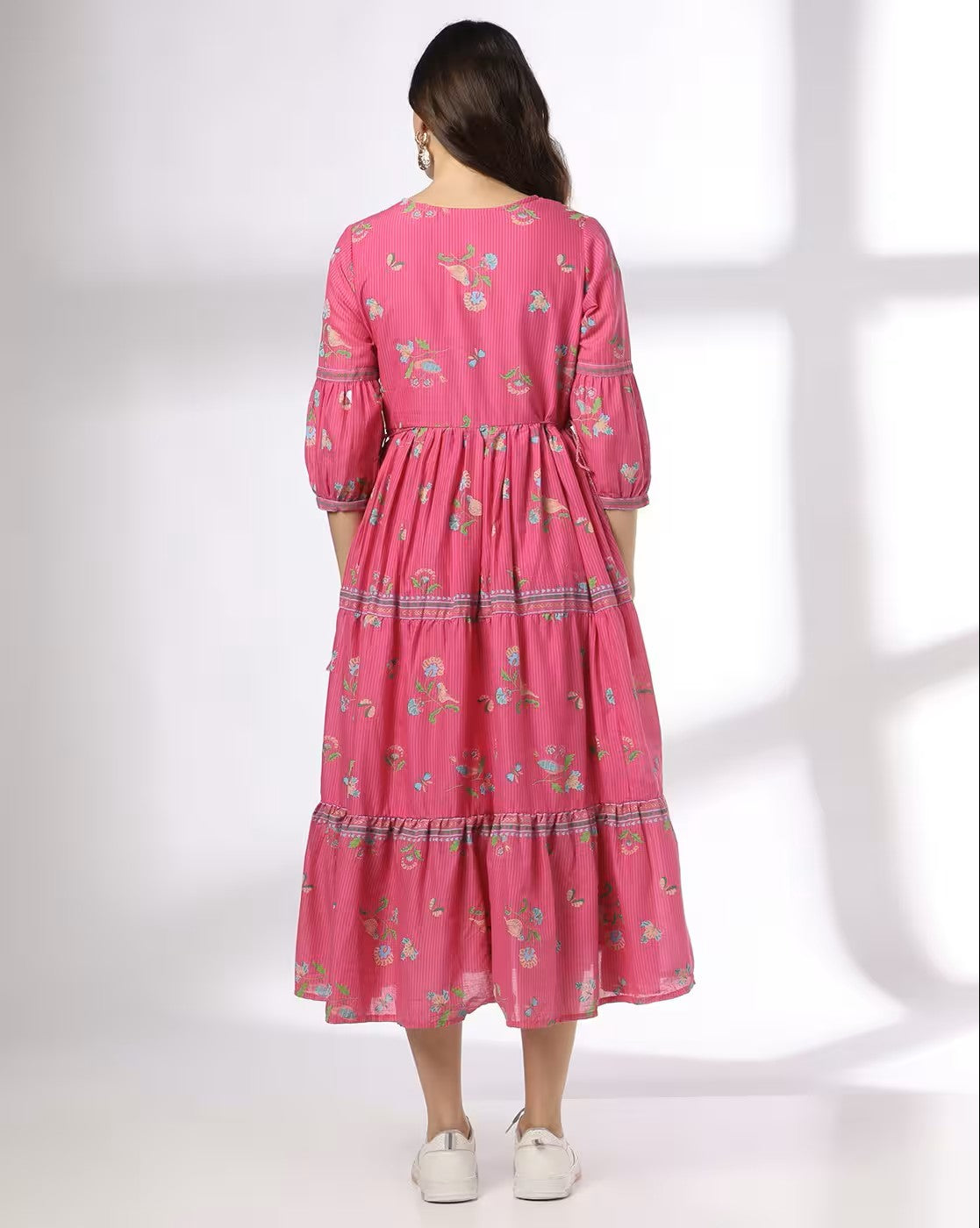 Aromie pink floral print tiered dress with three-quarter sleeves and midi length shown from back