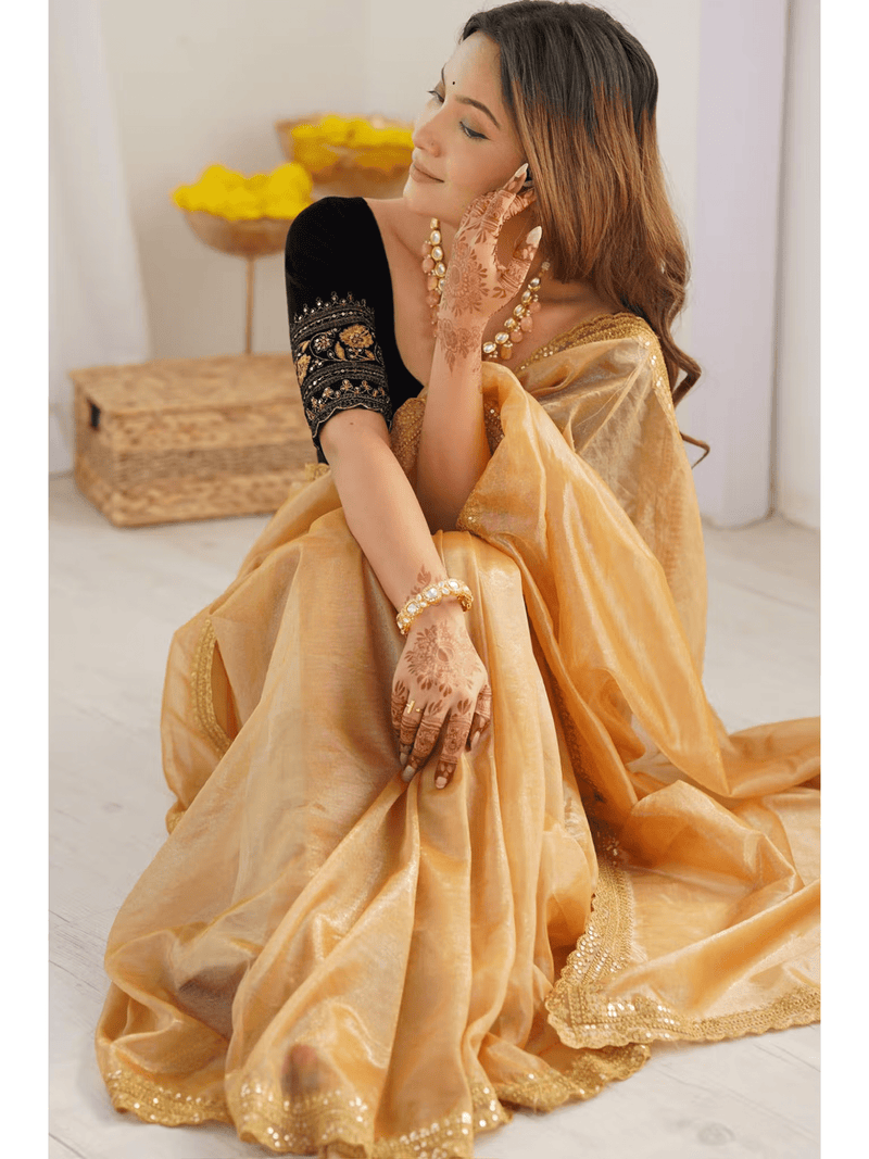 Aromie Gold Silk Party Wear Saree Canada draped on woman with black blouse and traditional jewelry
