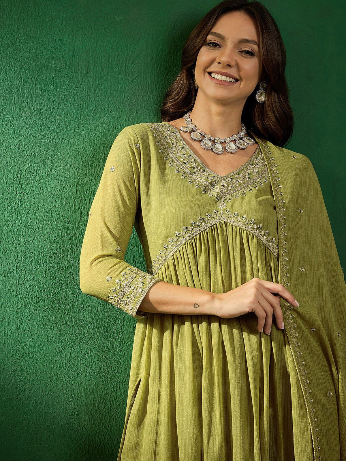 Front view of a green embroidered kurta set Canada featuring a flowing design, suitable for festive occasions.