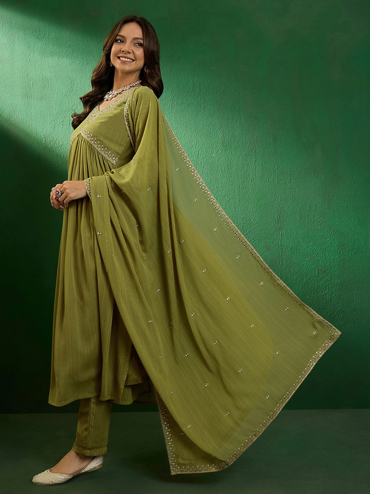 Green embroidered kurta set Canada featuring a flowing design, perfect for festive occasions.