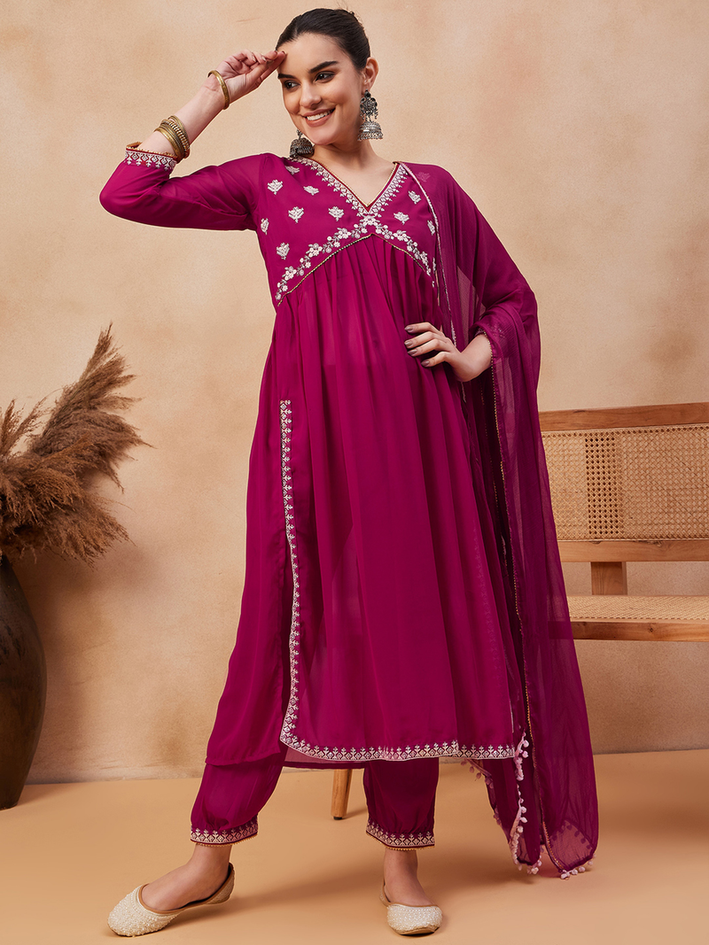 Elegant three piece kurta set in magenta with hand block printed details and embellished design