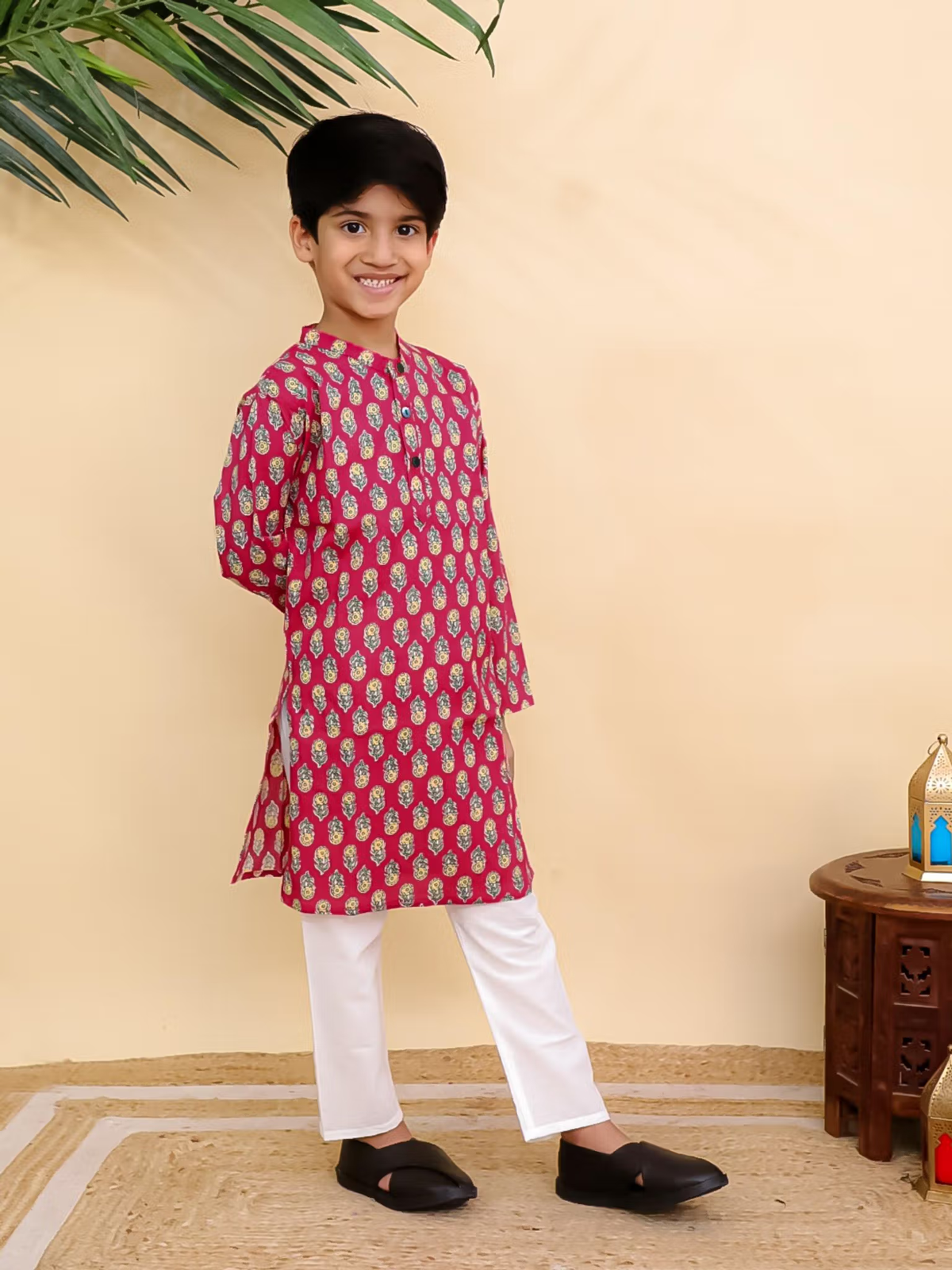 Smiling boy wearing red printed kurta pyjama set Canada with white pyjama and black slippers