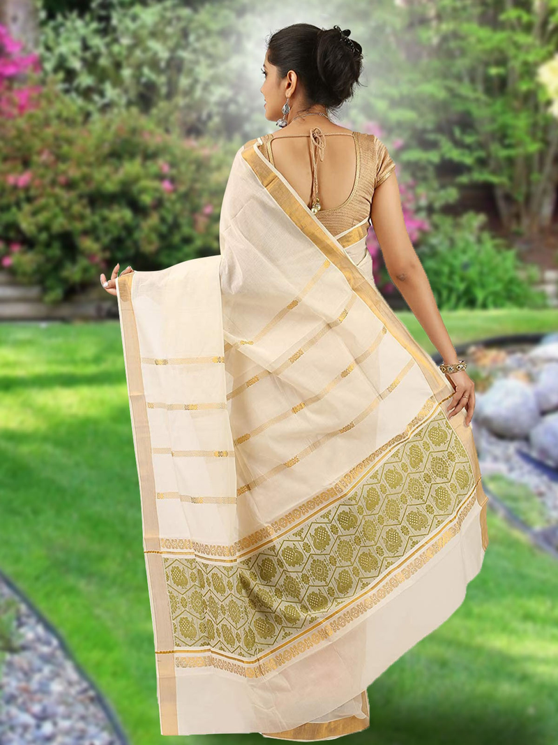 Aromie Ikat saree with zari border in cream and gold worn by a woman standing outdoors