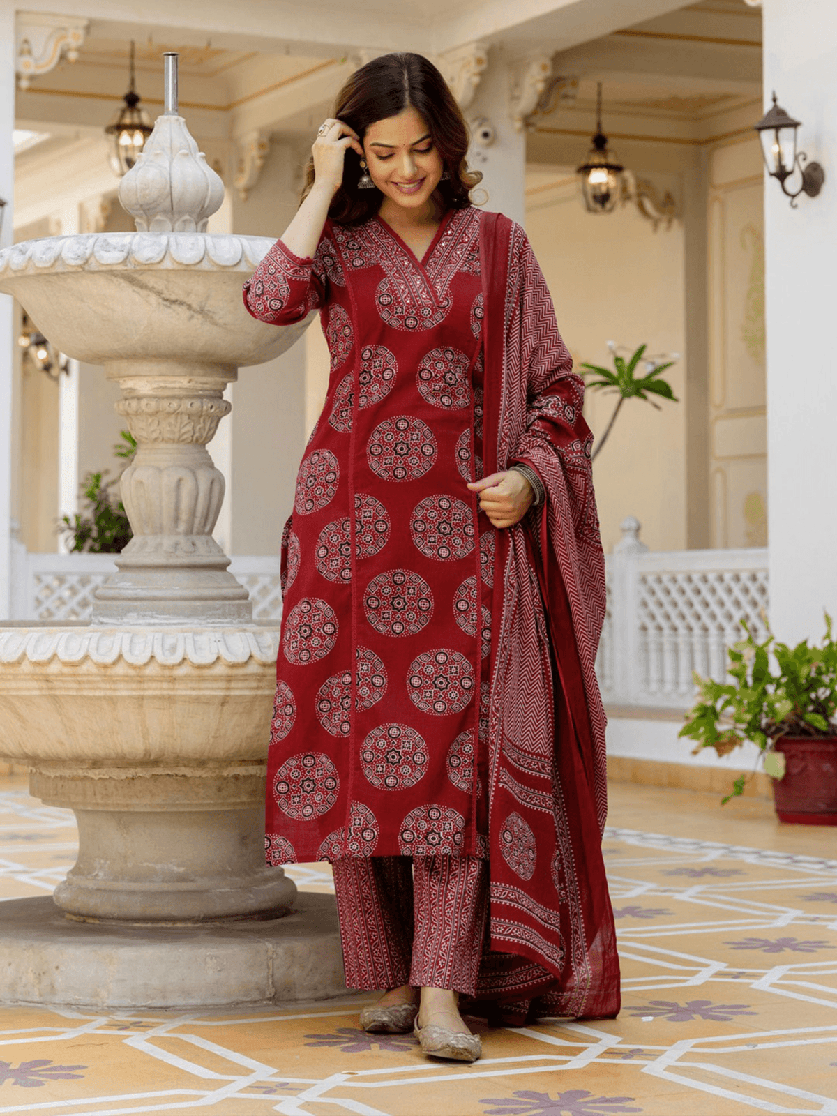 Aromie burgundy three-piece kurtha set in cotton with detailed patterns, ideal for festive occasions. Indian Clothing Online Canada.
