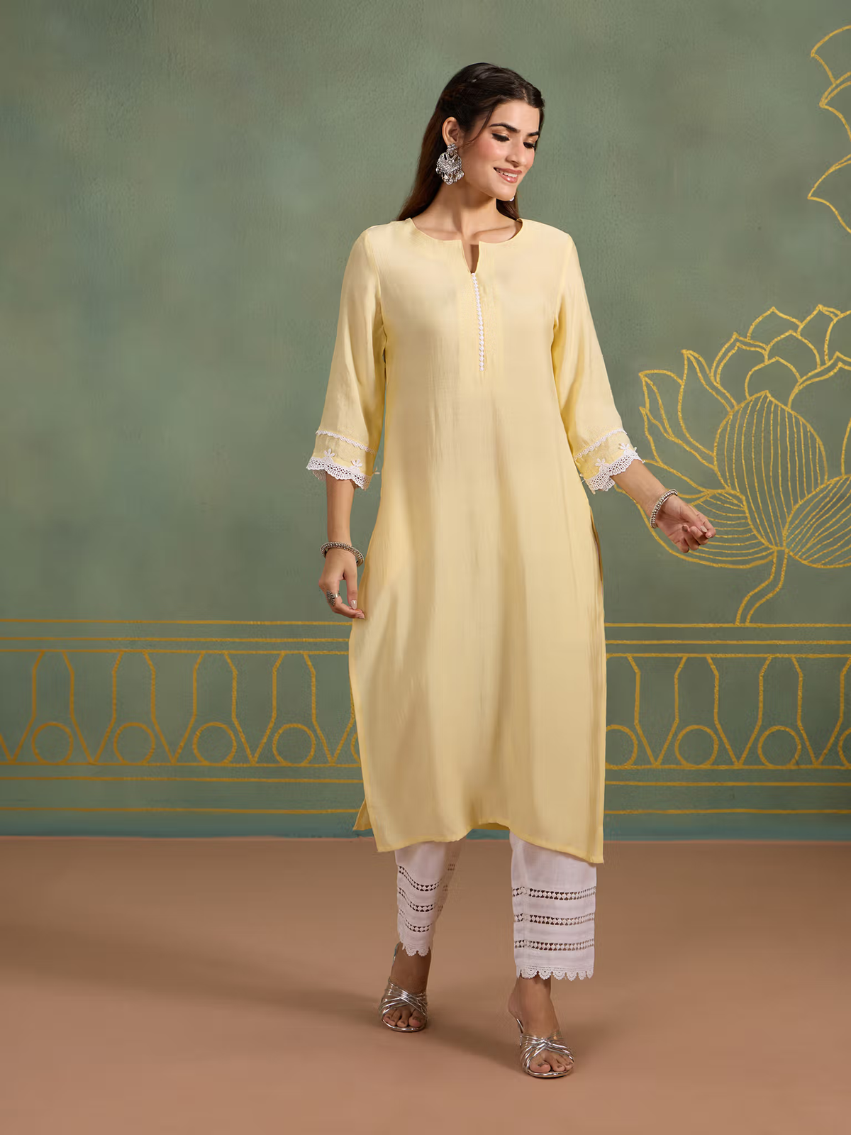 Aromie single piece kurta in soft yellow with lace detailing and white pants styled as Indian fusion jumpsuit