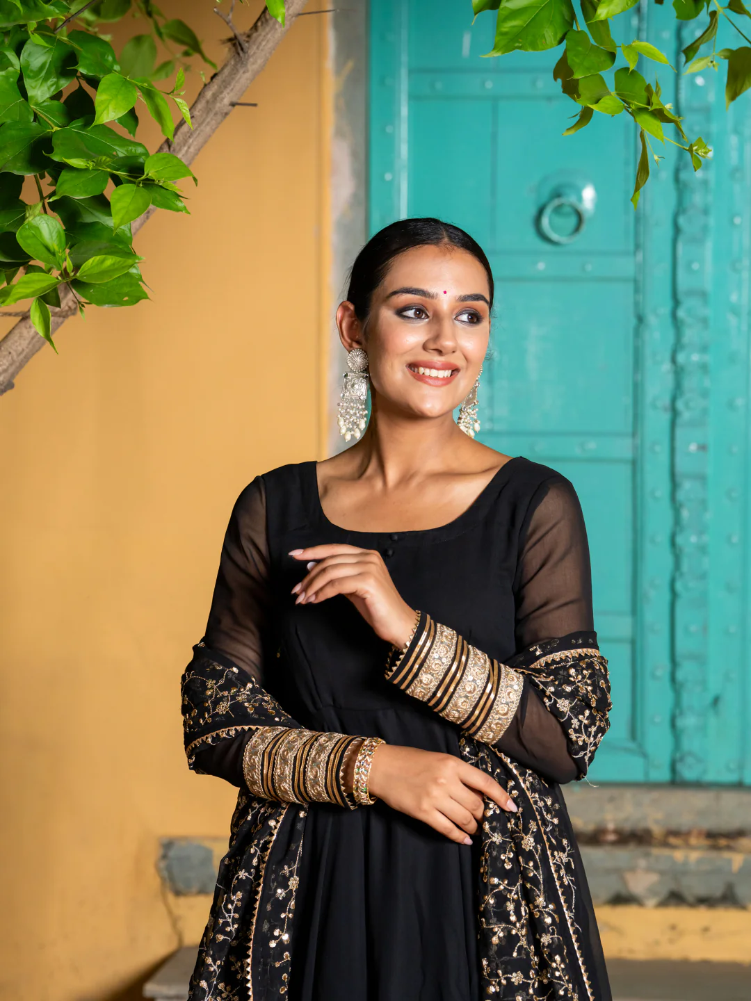 Black three piece kurta set for women in lightweight fabric, perfect for festive occasions with detailed embellishments