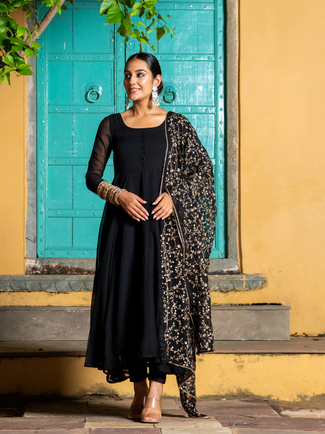 Black three piece kurta set for women in lightweight fabric, featuring a front view with detailed embroidery, perfect for festive occasions.