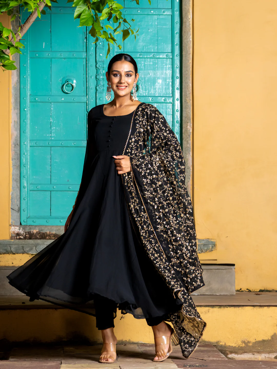 Elegant black kurta set for women featuring a flowy design with detailed floral overlay, perfect for festive occasions