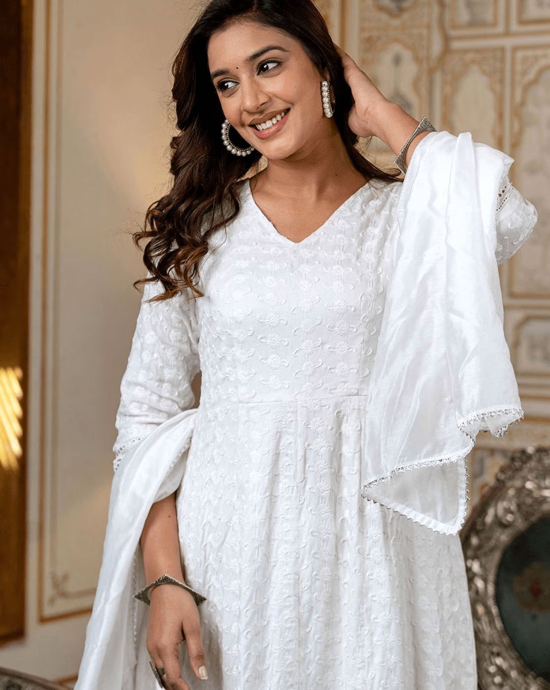 Elegant white Indian kurta set with dupatta featuring intricate embroidery and a flattering silhouette