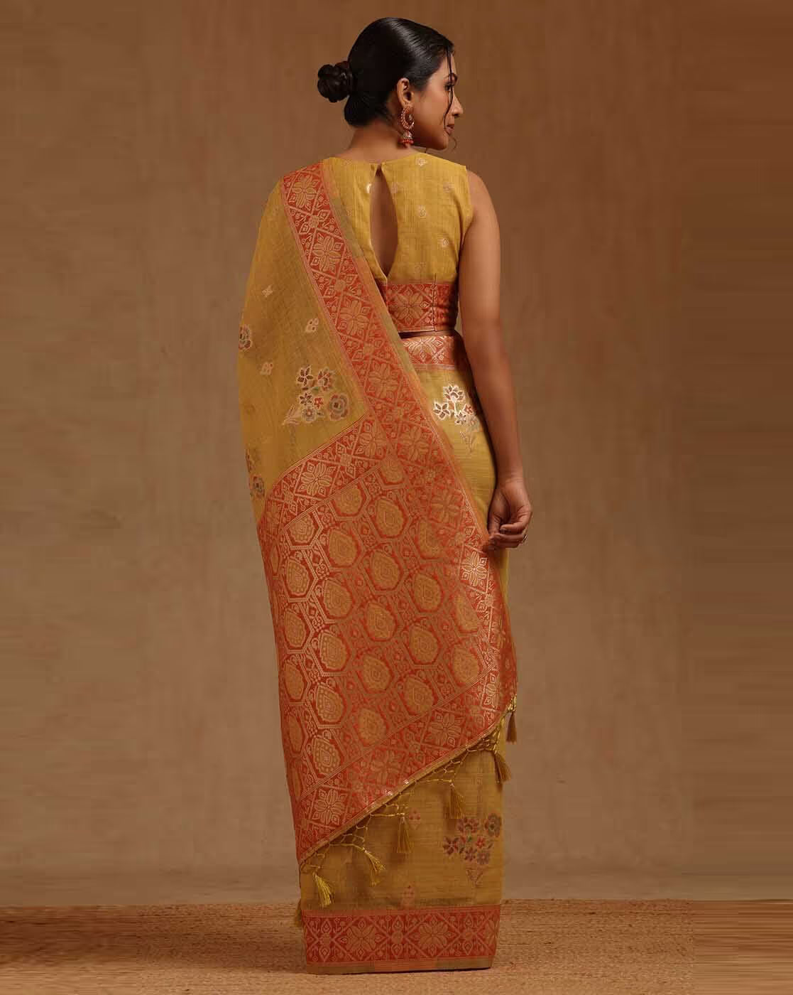 Front view of Kanjivaram saree in gold and orange silk, perfect for weddings in Canada.