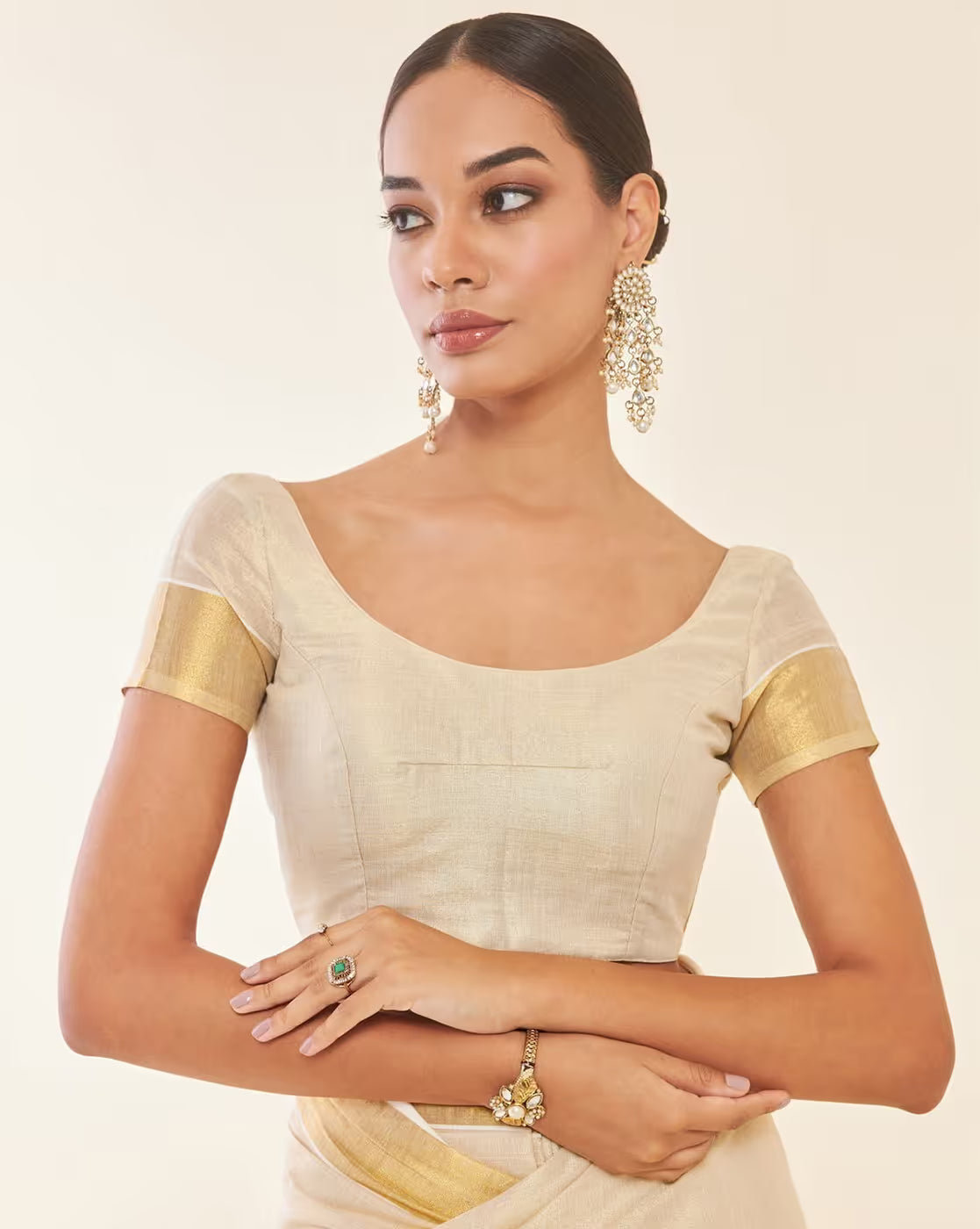 Elegant cream Kasavu Saree from aromie in lightweight fabric, ideal for weddings and festive occasions