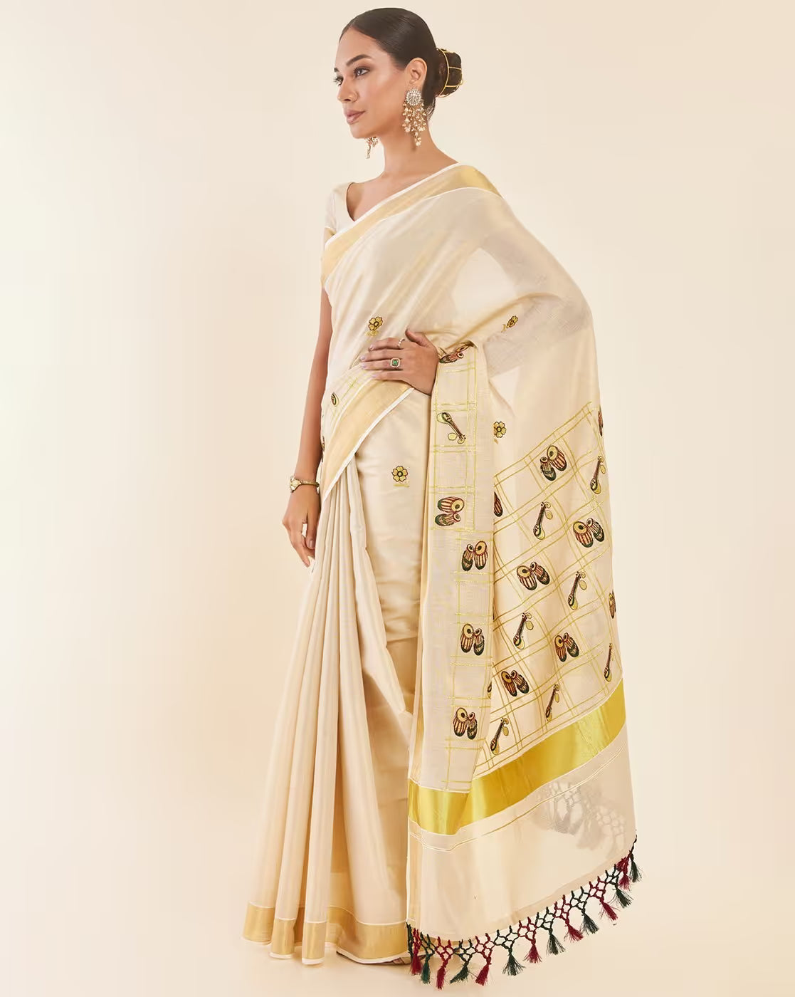 Elegant cream Kasavu Saree Canada with intricate embroidery and golden border, ideal for festive occasions