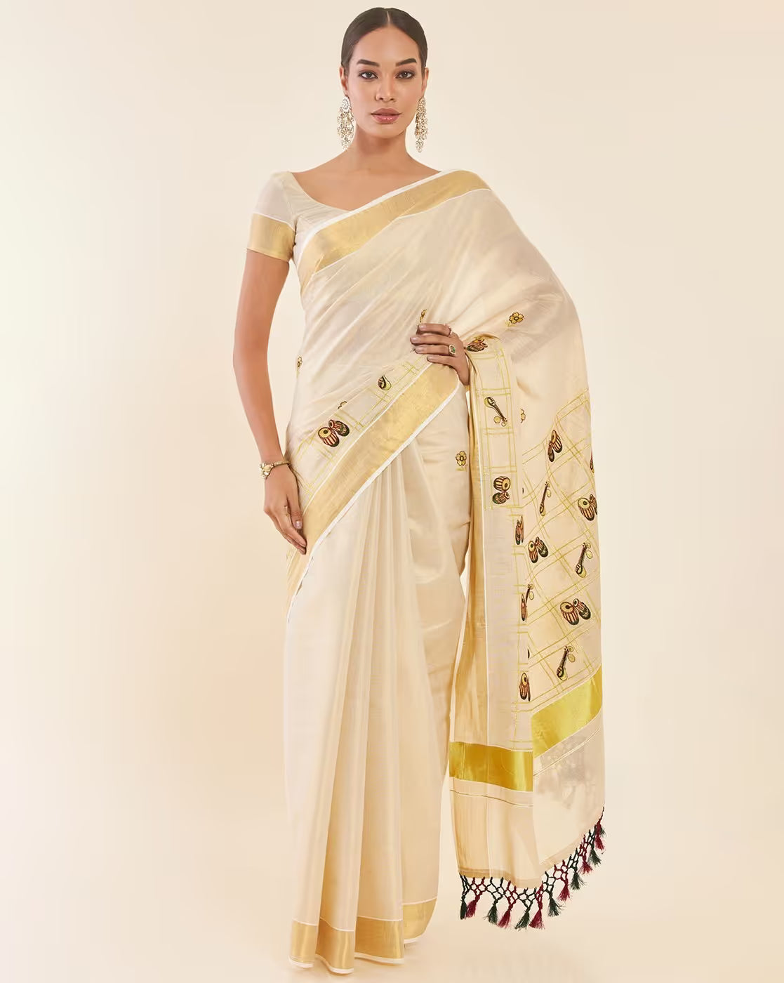 Elegant cream Kasavu Saree Canada with gold borders and intricate embroidery, perfect for festive occasions