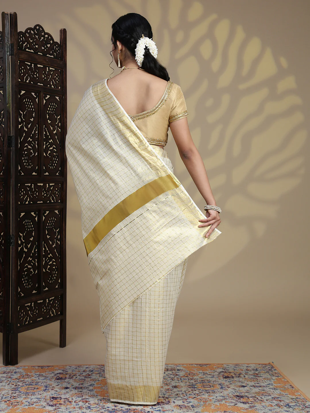 Elegant cream Kerala Saree with golden border in soft fabric, perfect for weddings or festive occasions