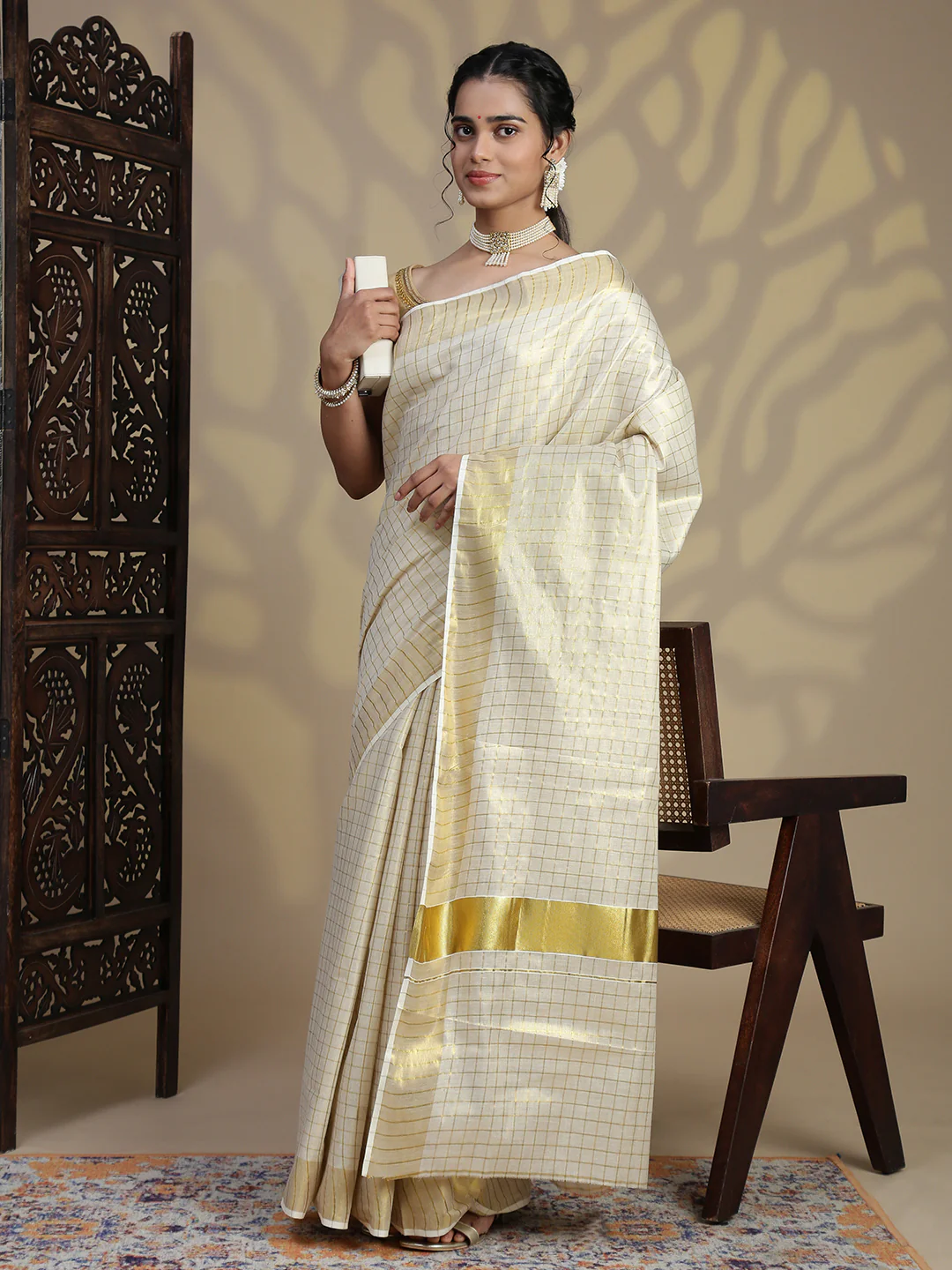 Elegant cream Kerala Saree from Aromie with gold accents, ideal for festive occasions in Canada