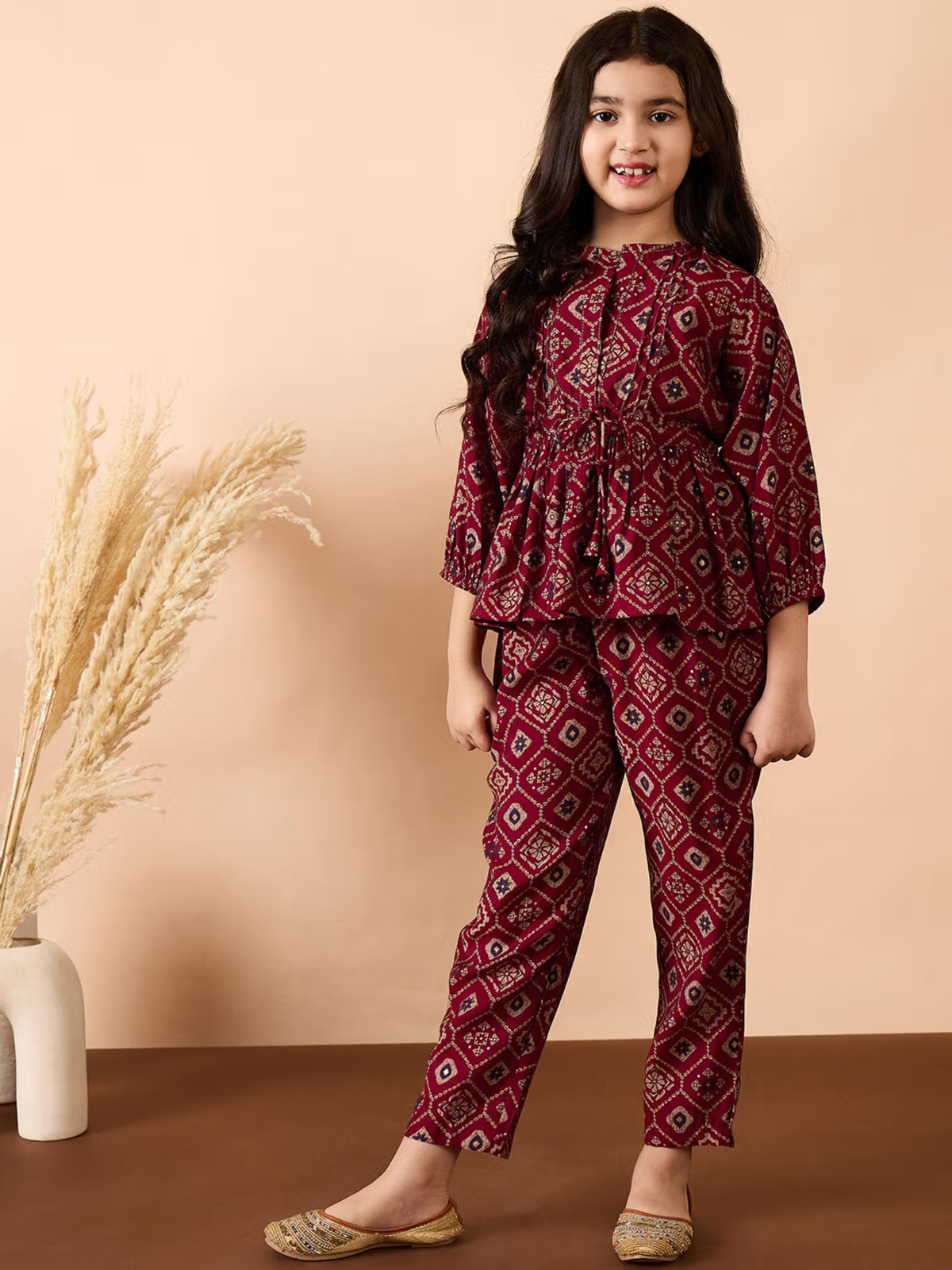 Aromie Girls model in maroon printed peplum top and matching pants for festive wear Girls Georgette Kurta Set