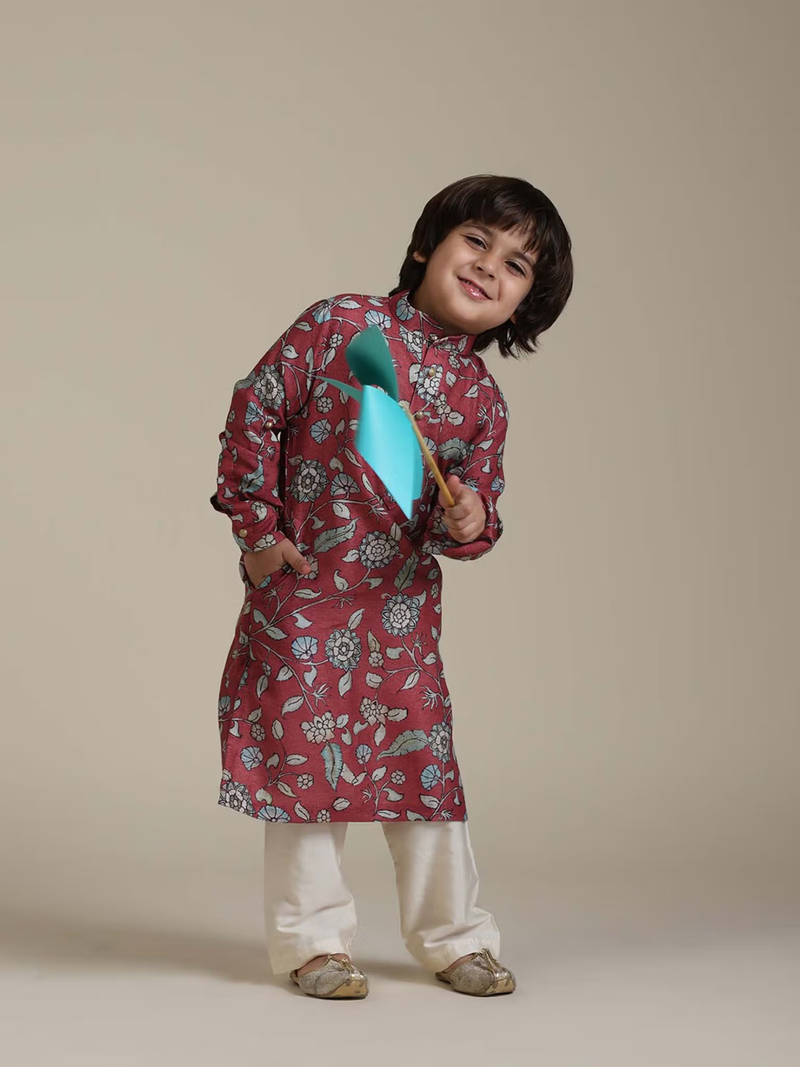 Young boy wearing kids rust floral kurta pyjama set with white pajama pants and traditional shoes