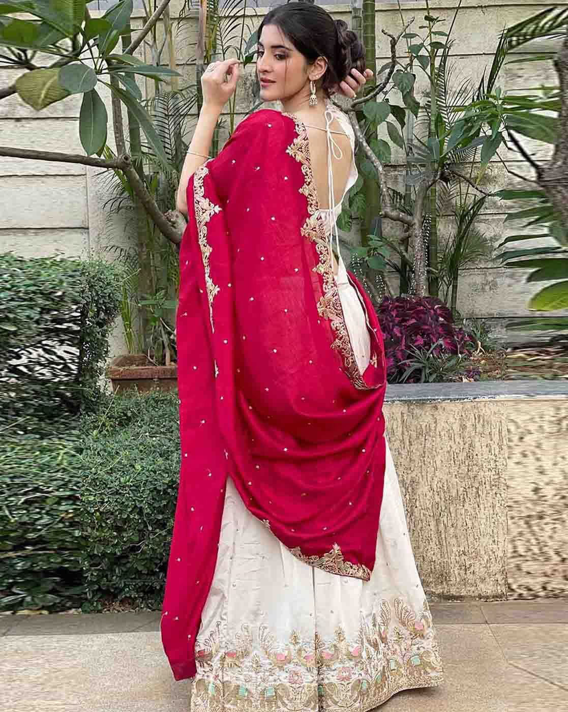 Elegant lehenga choli set Canada featuring a embroidered red dupatta and white skirt with floral embellishments