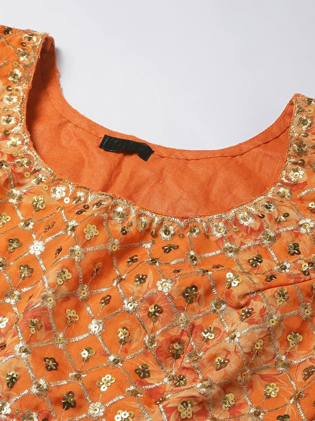 Front view of an orange lehenga choli set Canada with intricate gold embellishments for festive occasions