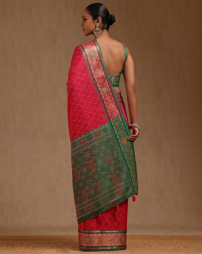 Elegant linen saree in bright pink and green with intricate detailing, ideal for weddings in Canada.