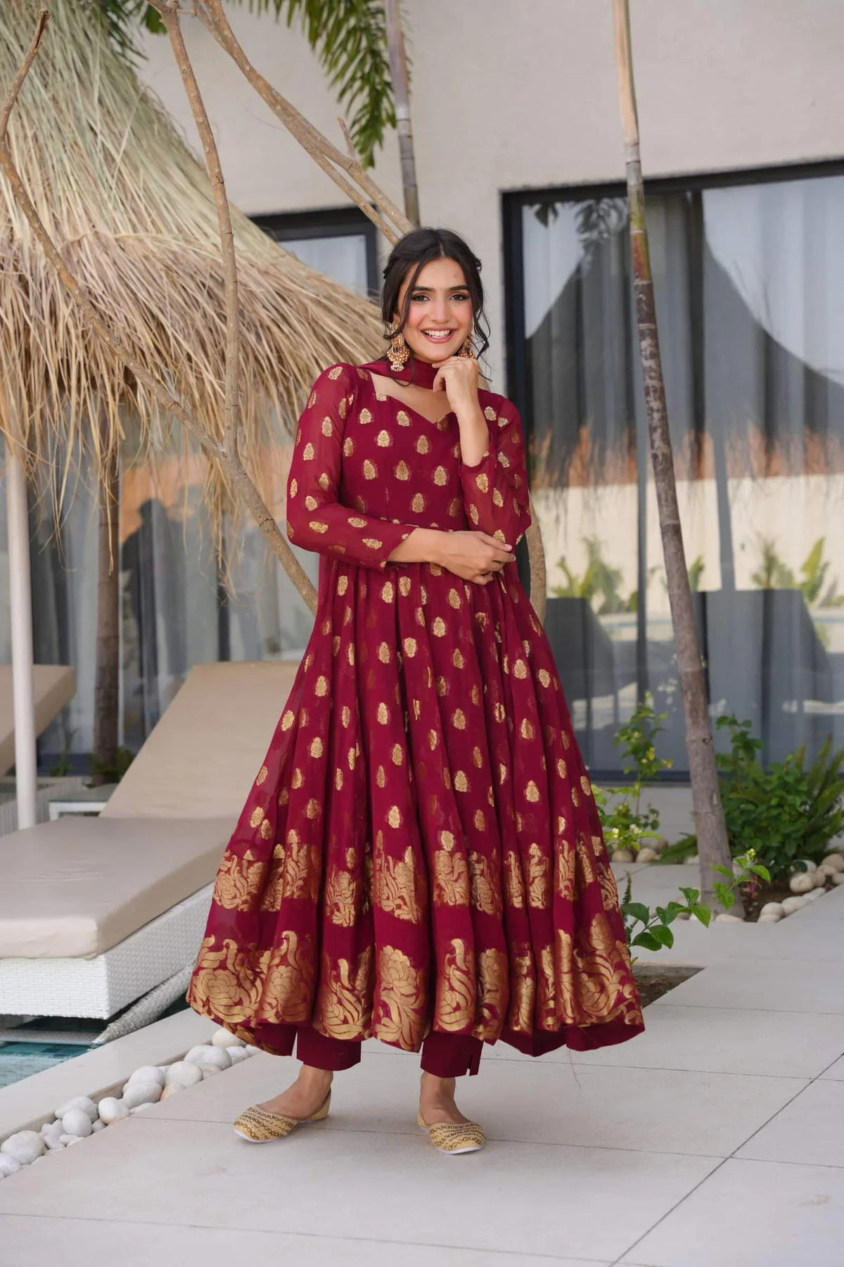 Maroon anarkali suit set in elegant fabric featuring gold floral patterns, perfect for festive occasions
