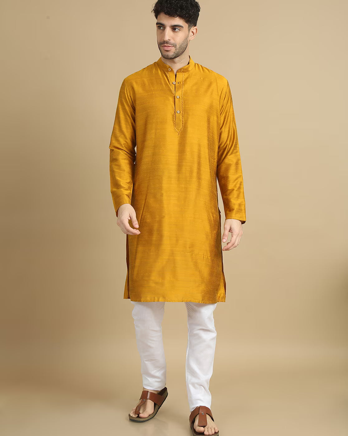 Stylish men's cotton kurta pyjama set in mustard color, perfect for casual and festive occasions.