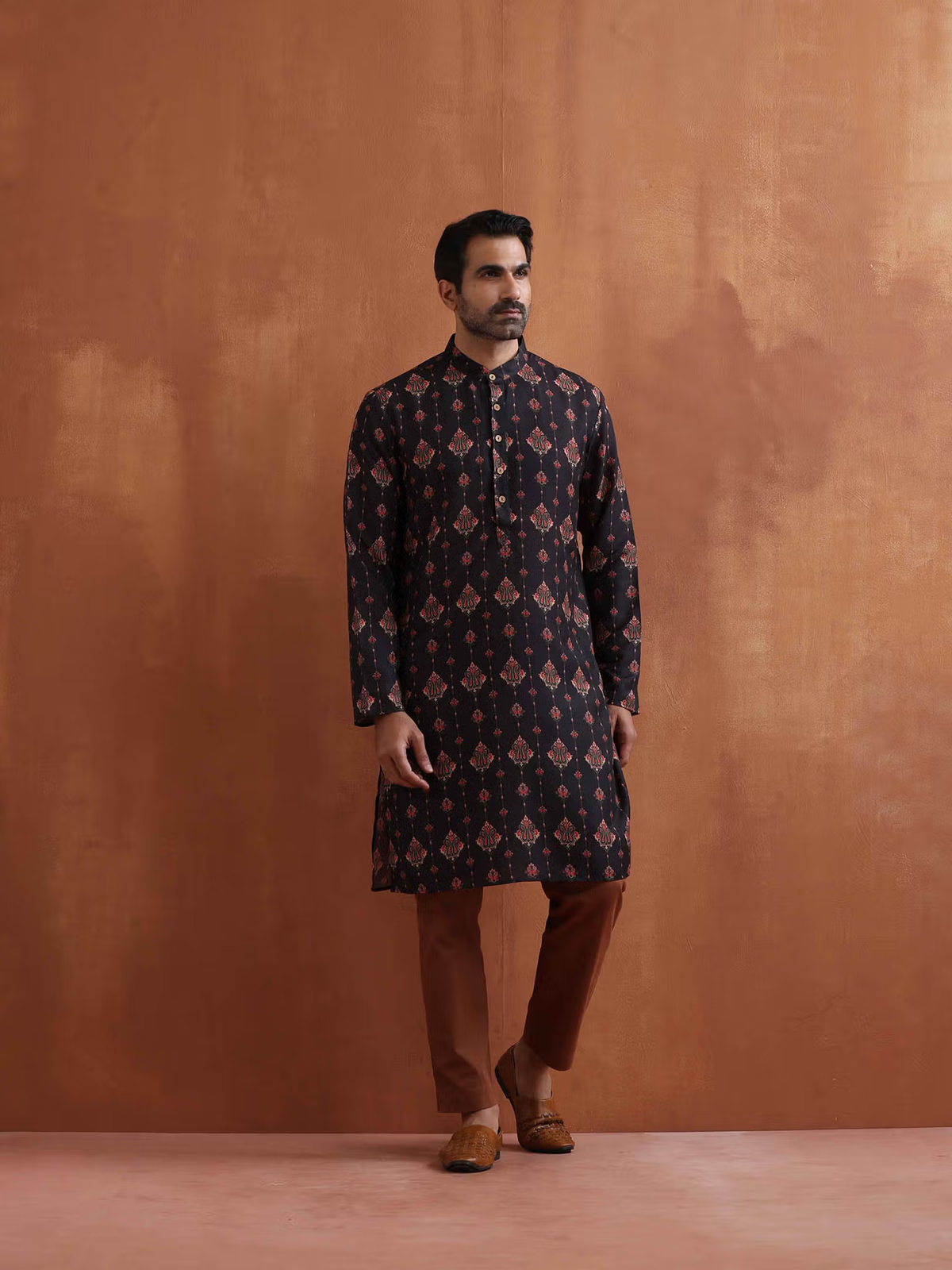 AROMIE men's black printed kurta with band collar and button placket paired with brown pants and tan loafers