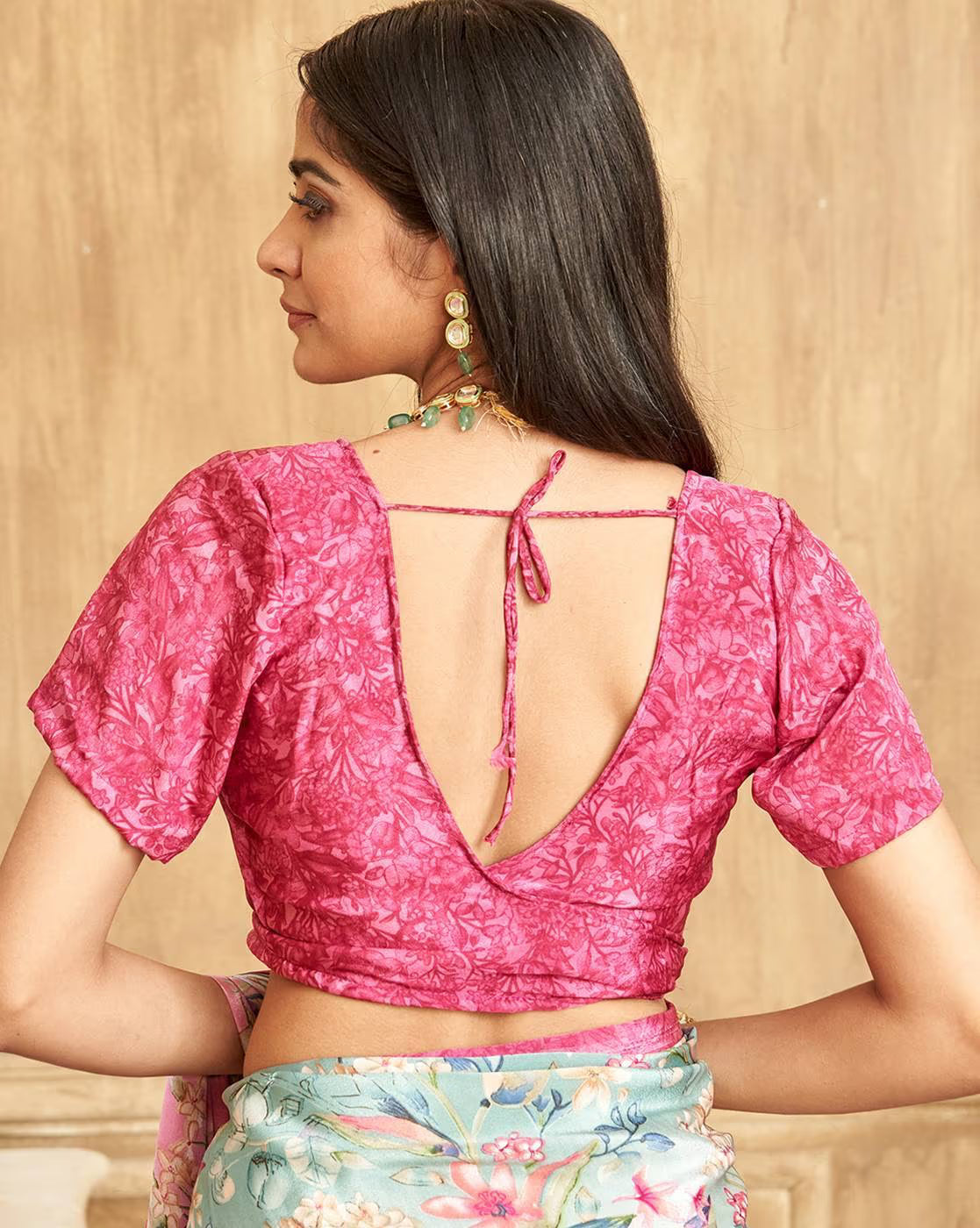 Back view of a woman wearing a pink blouse with a Multicolor Tussar Silk Saree displayed elegantly