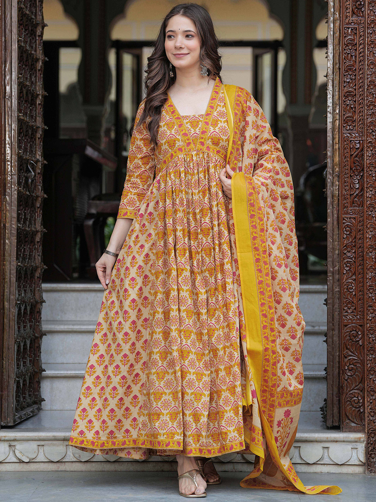 Mustard yellow anarkali kurta set in lightweight fabric, featuring a floral design, ideal for festive occasions.