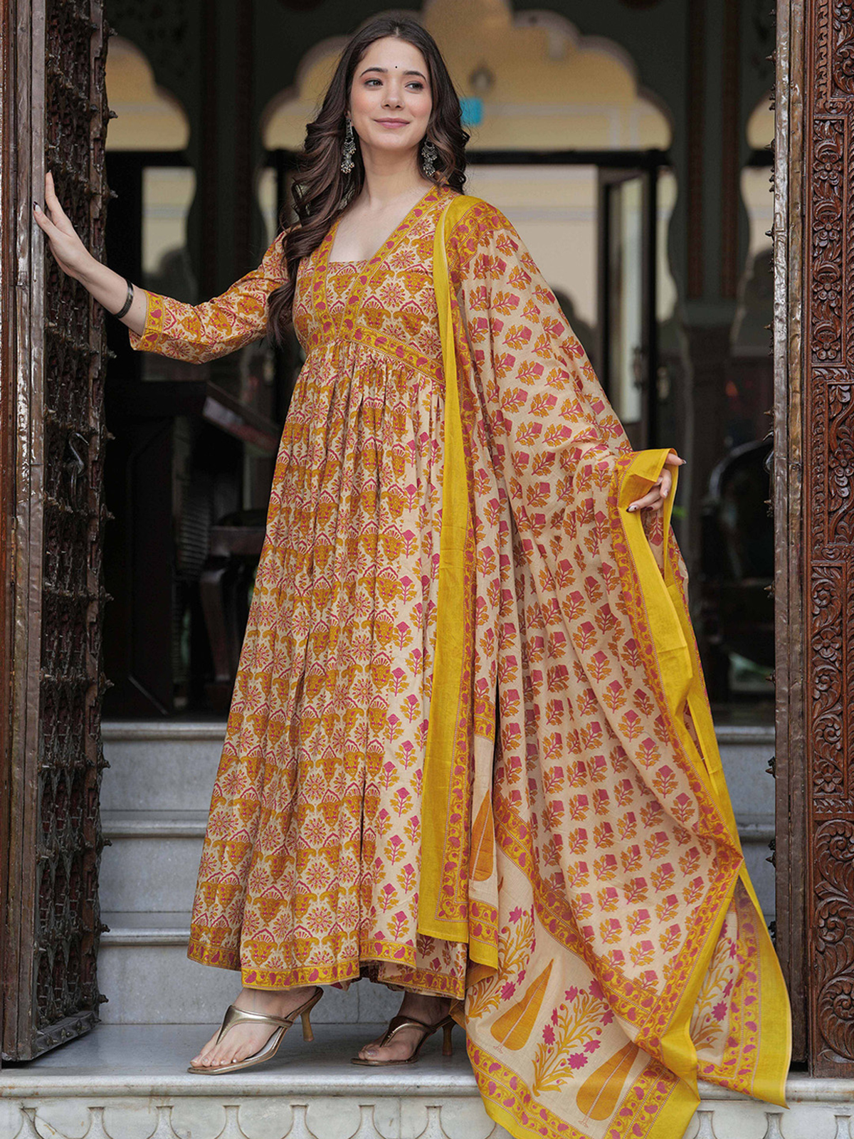 Front view of a mustard yellow anarkali kurta set in floral print, perfect for festive occasions.