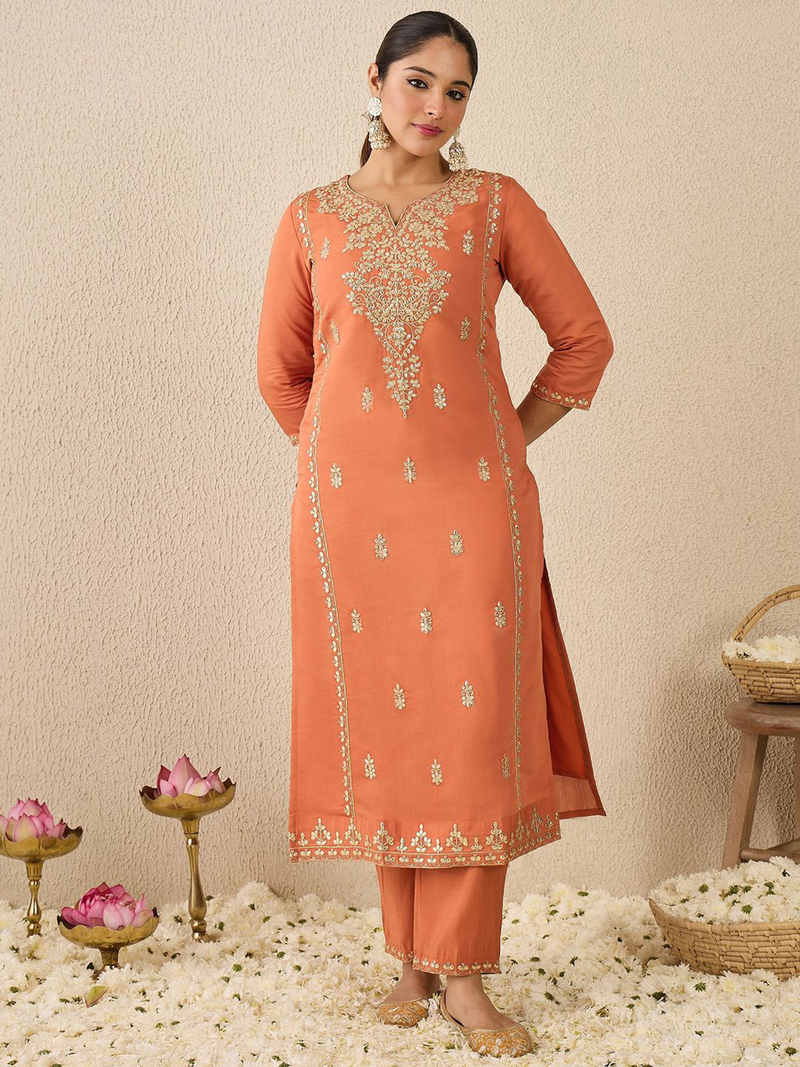 Elegant orange dress with intricate embroidery, perfect for festive occasions or celebrations
