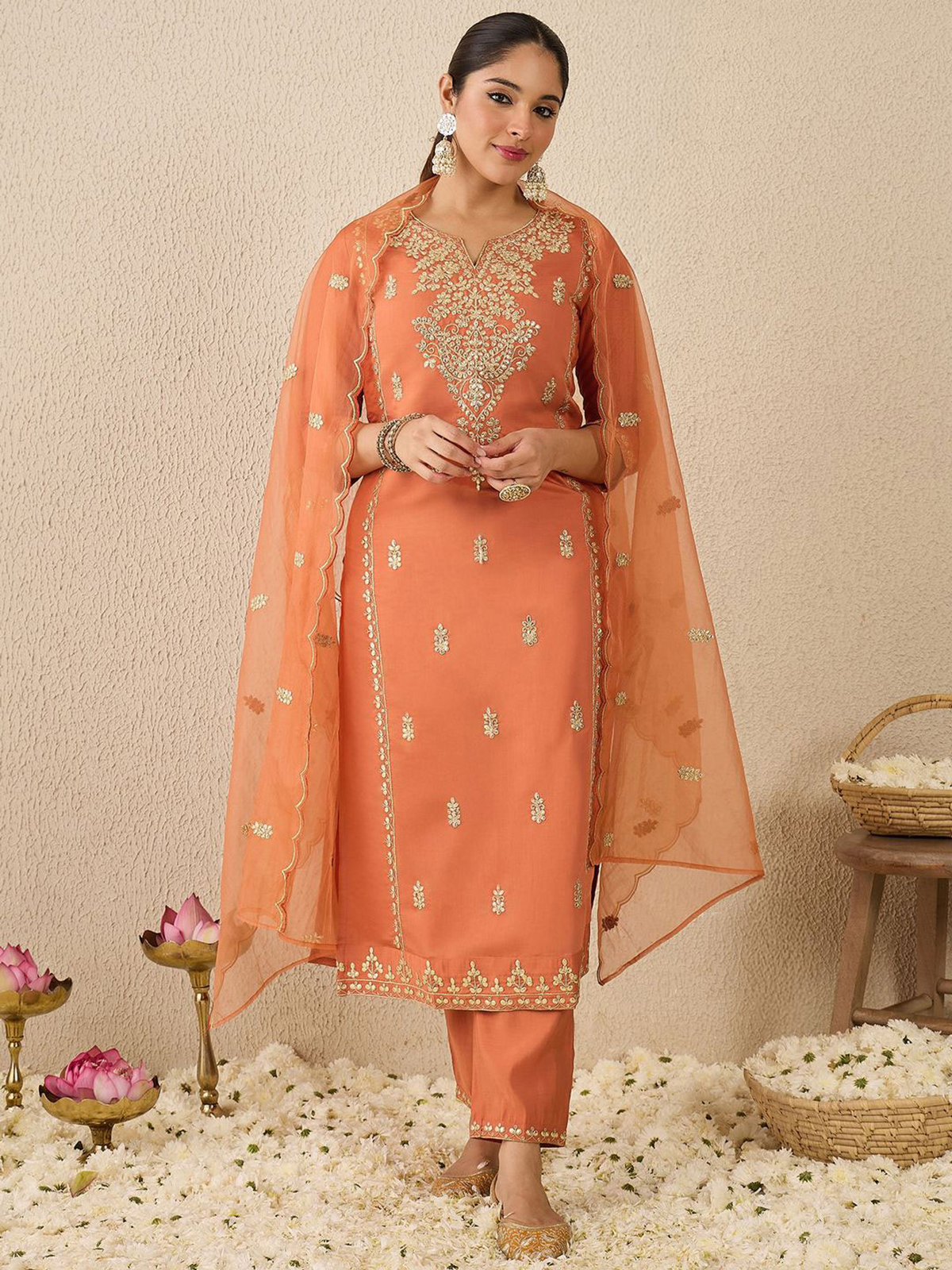 Elegant peach dress with floral embroidery and matching sheer dupatta for festive occasions