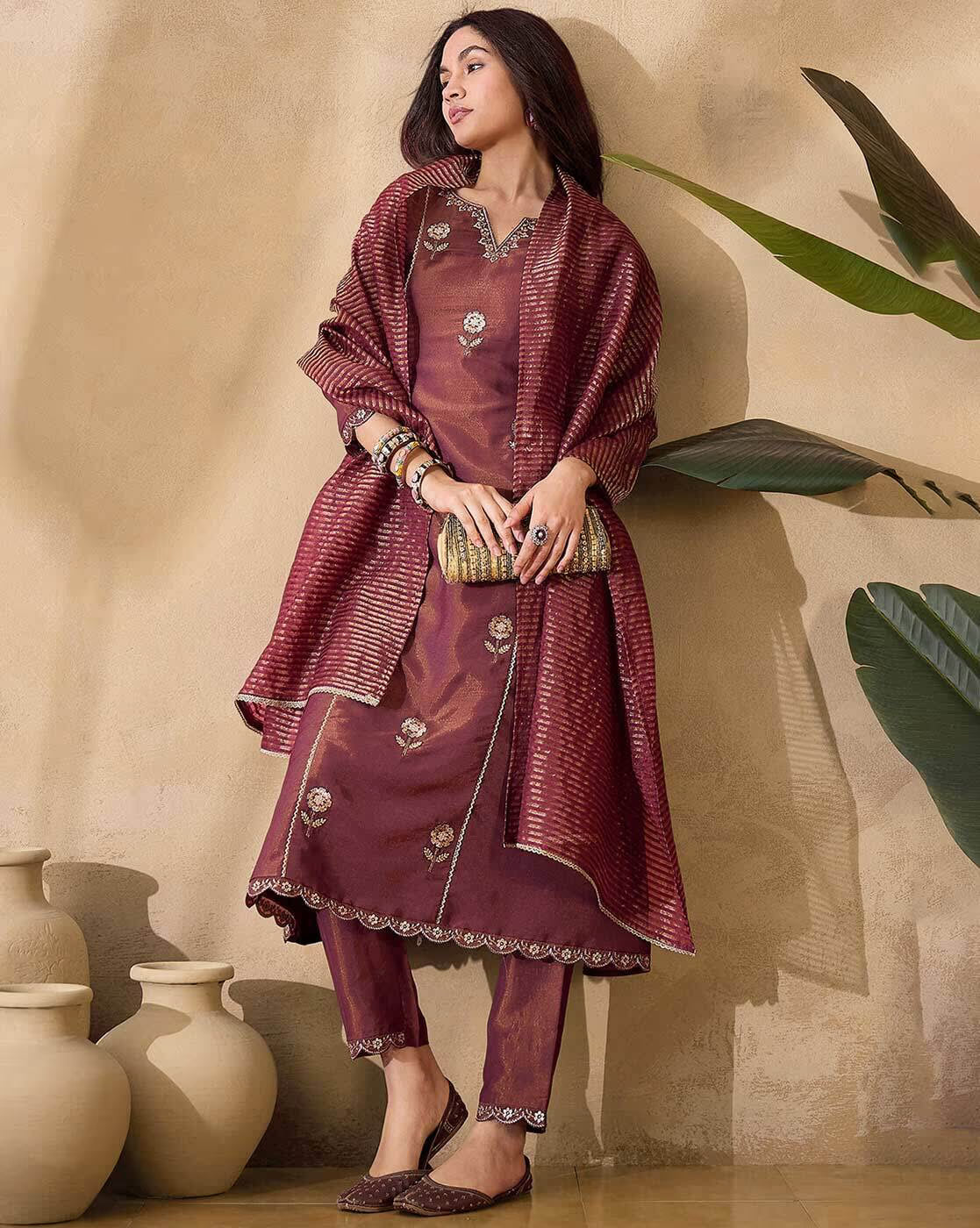 Aromie net embroidered kurta set in maroon with intricate detailing and matching accessories