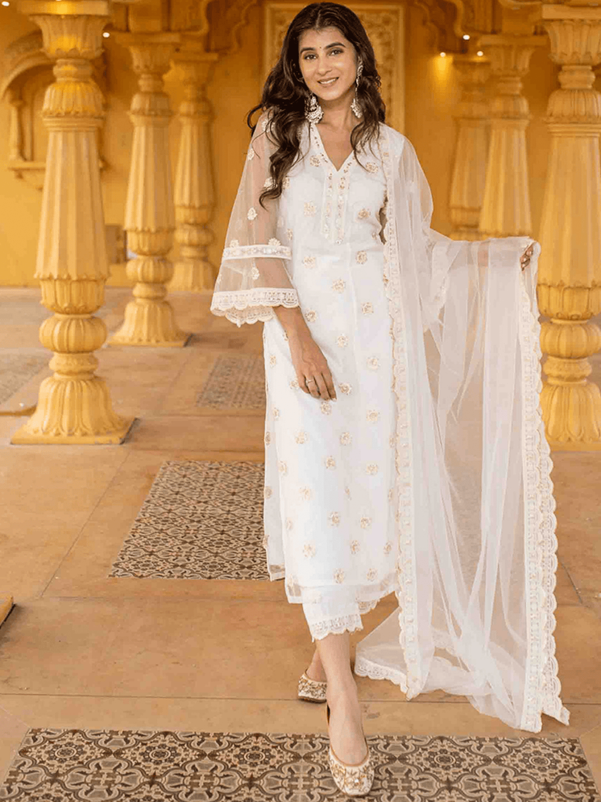 Elegant three piece Kurtha set featuring a net embroidered kurta set with floral designs and sheer dupatta