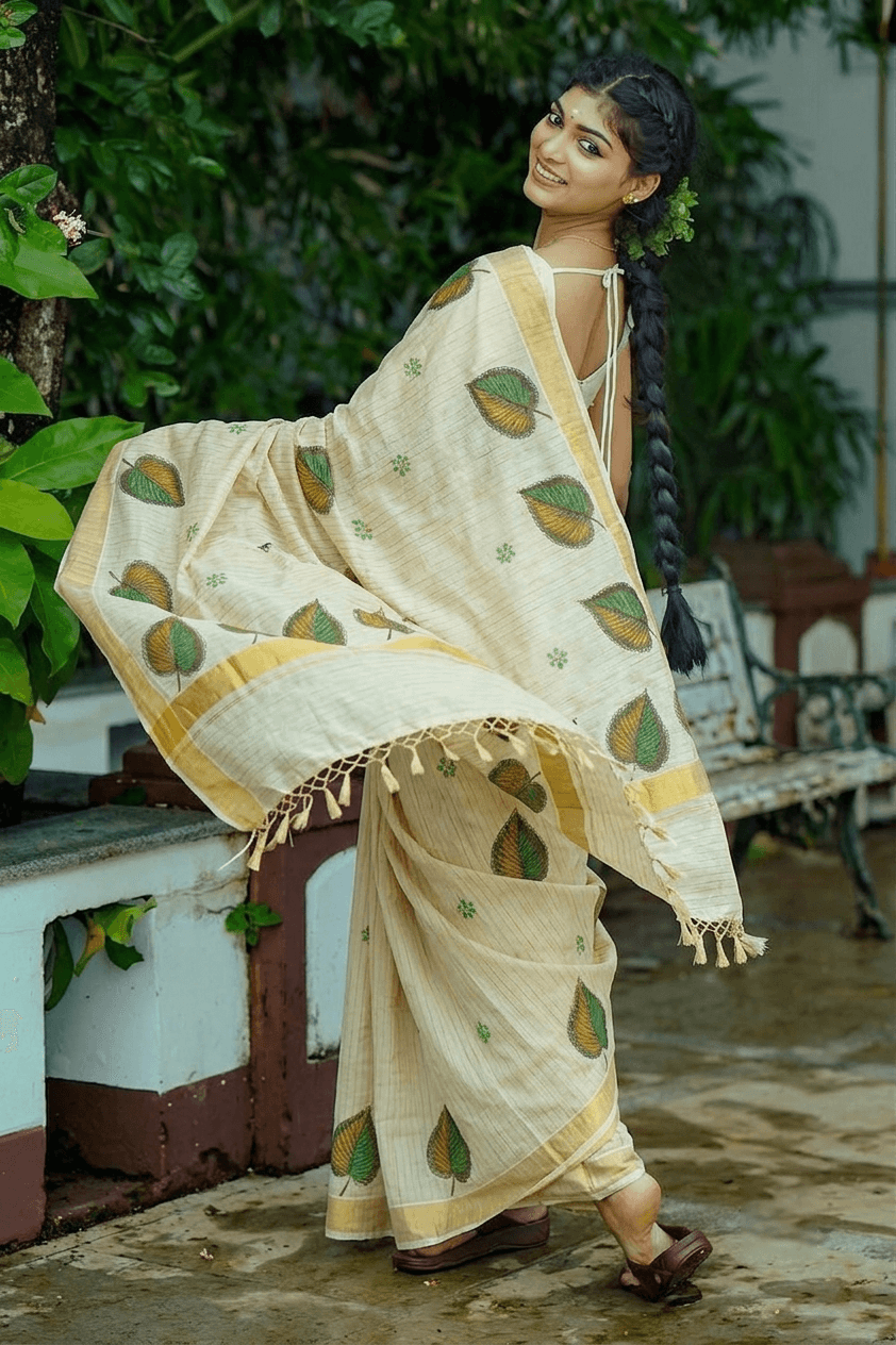 Elegant cream Onam Saree Canada made of lightweight fabric with leaf patterns, perfect for festive occasions