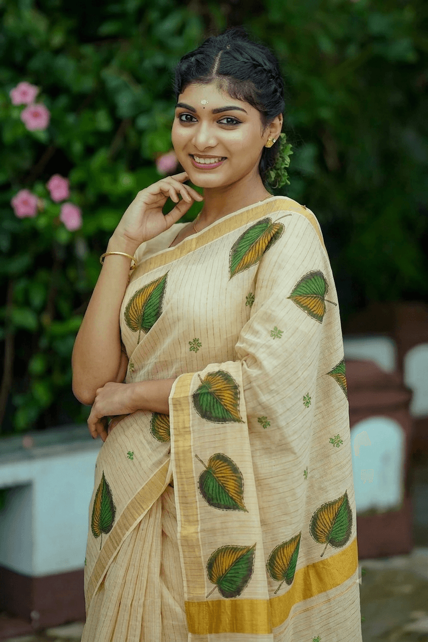 Aromie Onam Saree Canada in beige with leaf patterns, ideal for festive occasions and cultural celebrations